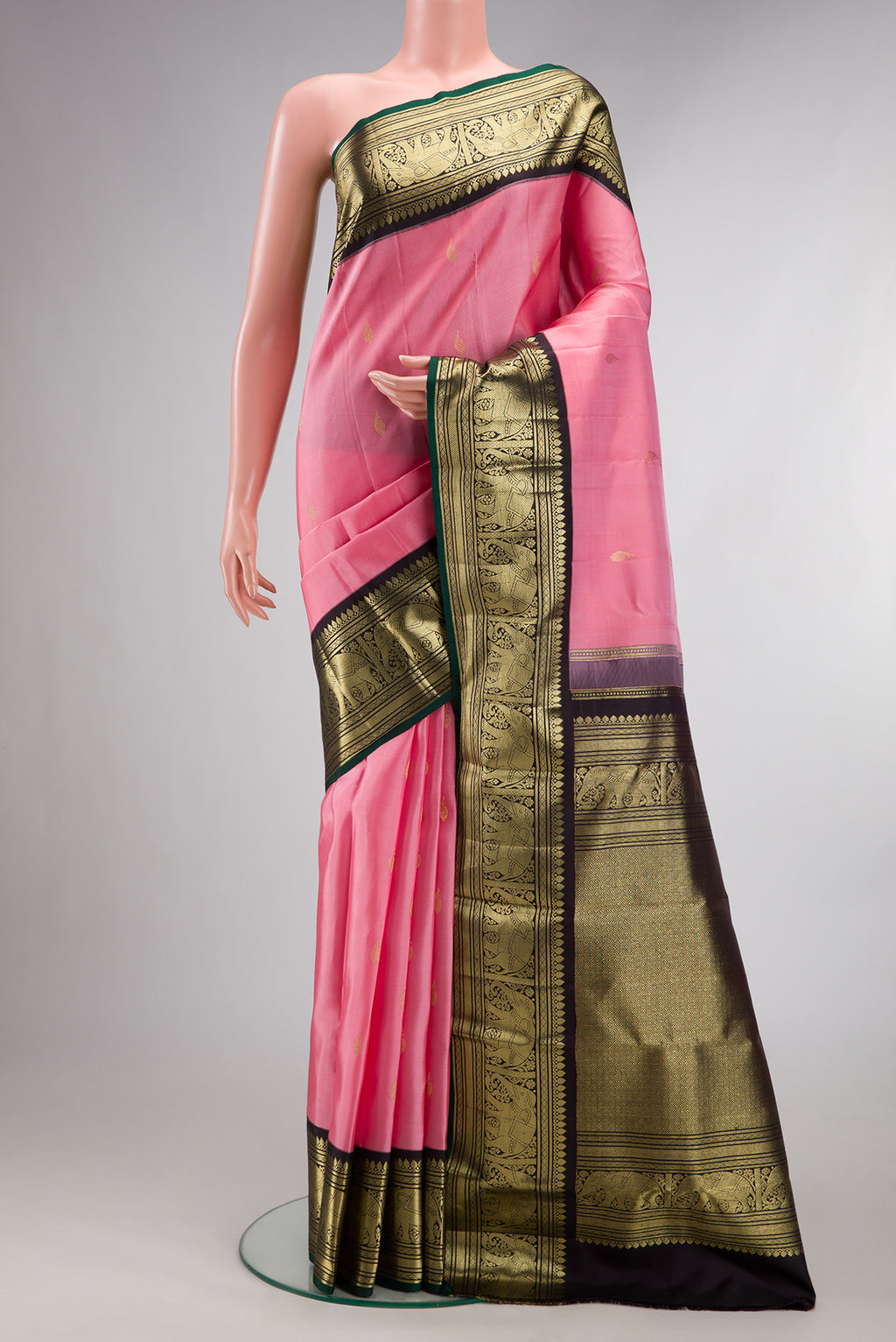 Pure Silk Pink Kanjivaram Saree with Zari Butta on the body and Fancy Border.  displayed on a mannequin
