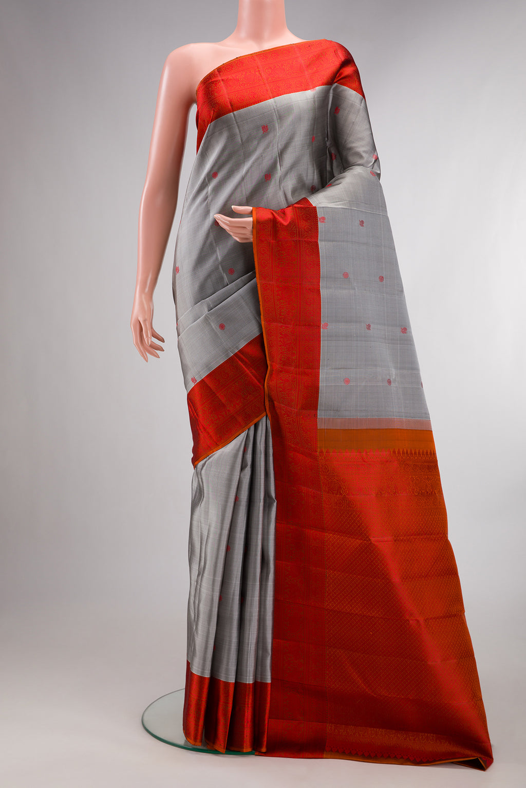 Pure Silk Grey Kanchipuram Saree with Thread Butta on the body and Thread Border.  displayed on a mannequin