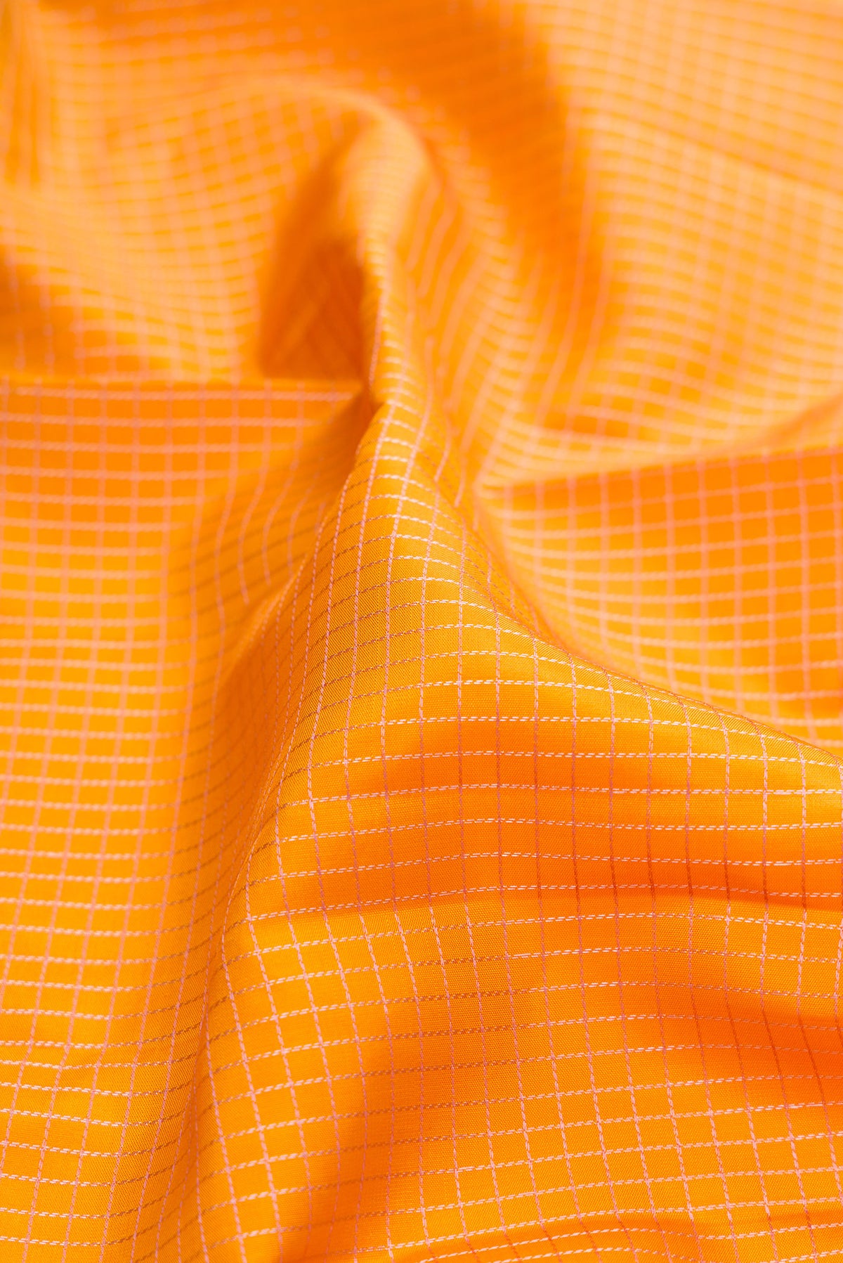 Close up of Pure Silk Mustard Kanjivaram Saree with Checked design on the body and Zari Border.  displaying folds