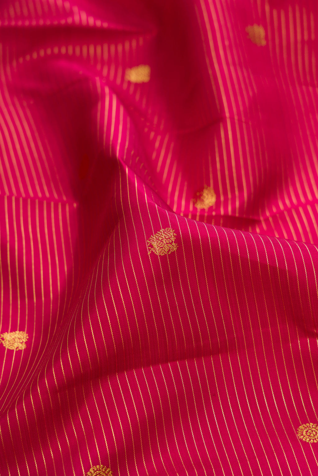 Close up of Pure Silk Maroon Kanjivaram Saree with Stripes on the body and Zari Border.  displaying folds