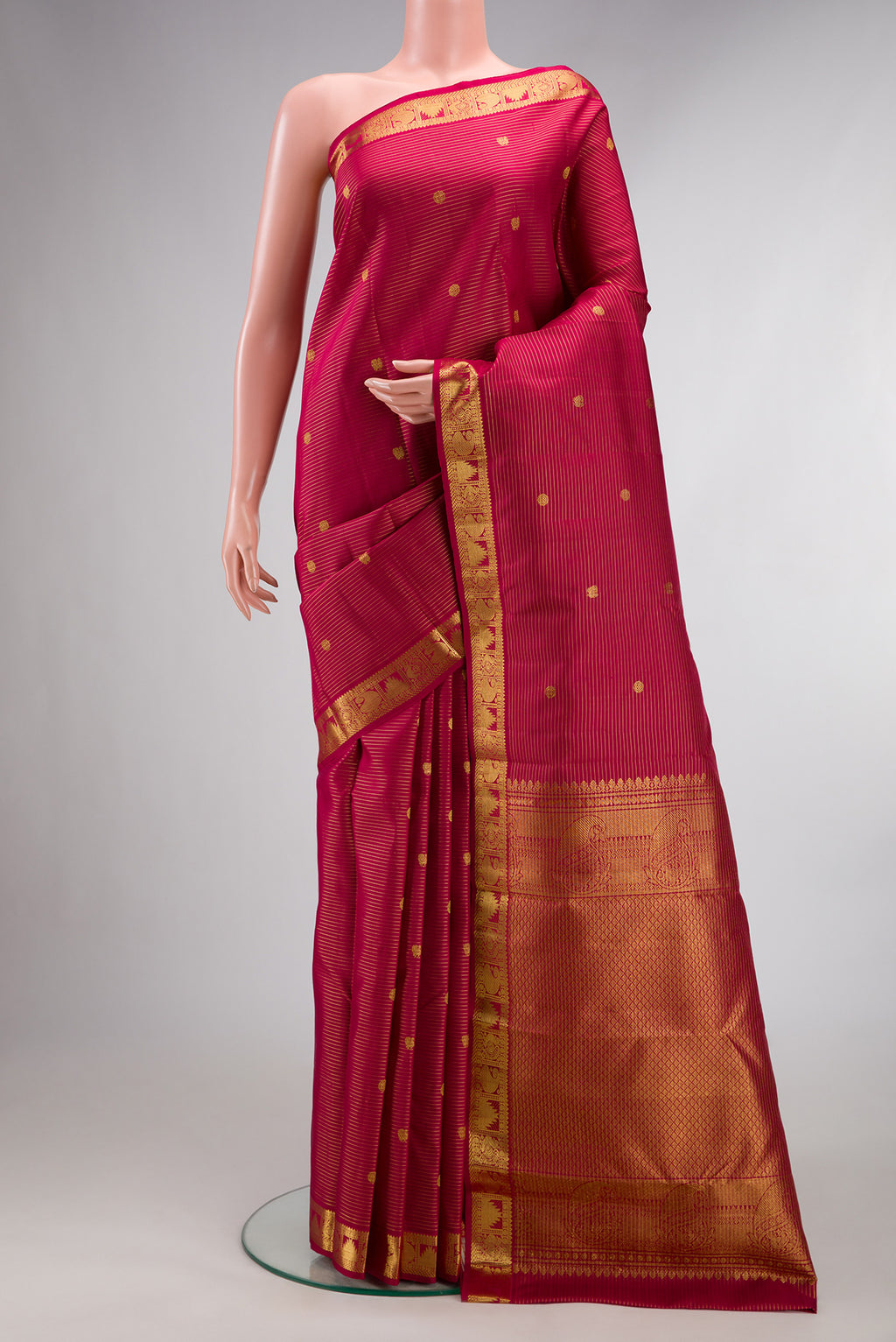 Pure Silk Maroon Kanjivaram Saree with Stripes on the body and Zari Border.  displayed on a mannequin