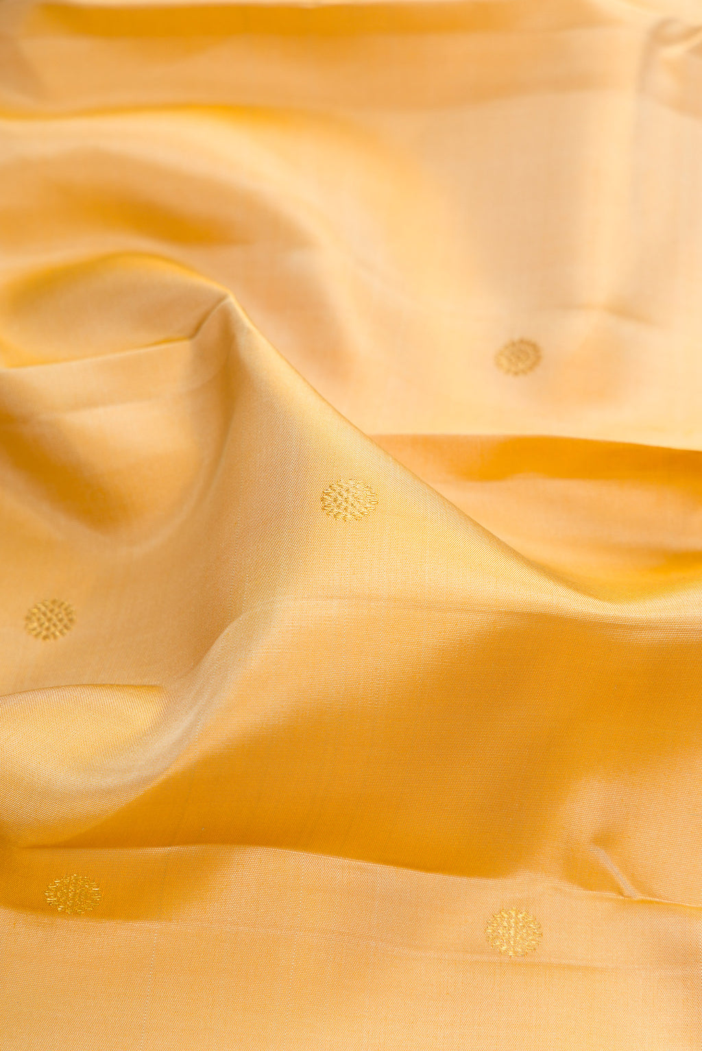 Close up of Pure Silk Sandal Kanchipuram Saree with Zari Butta on the body and Zari Border.  displaying folds