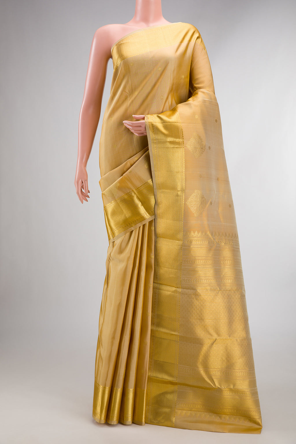 Pure Silk Sandal Kanchipuram Saree with Zari Butta on the body and Zari Border.  displayed on a mannequin