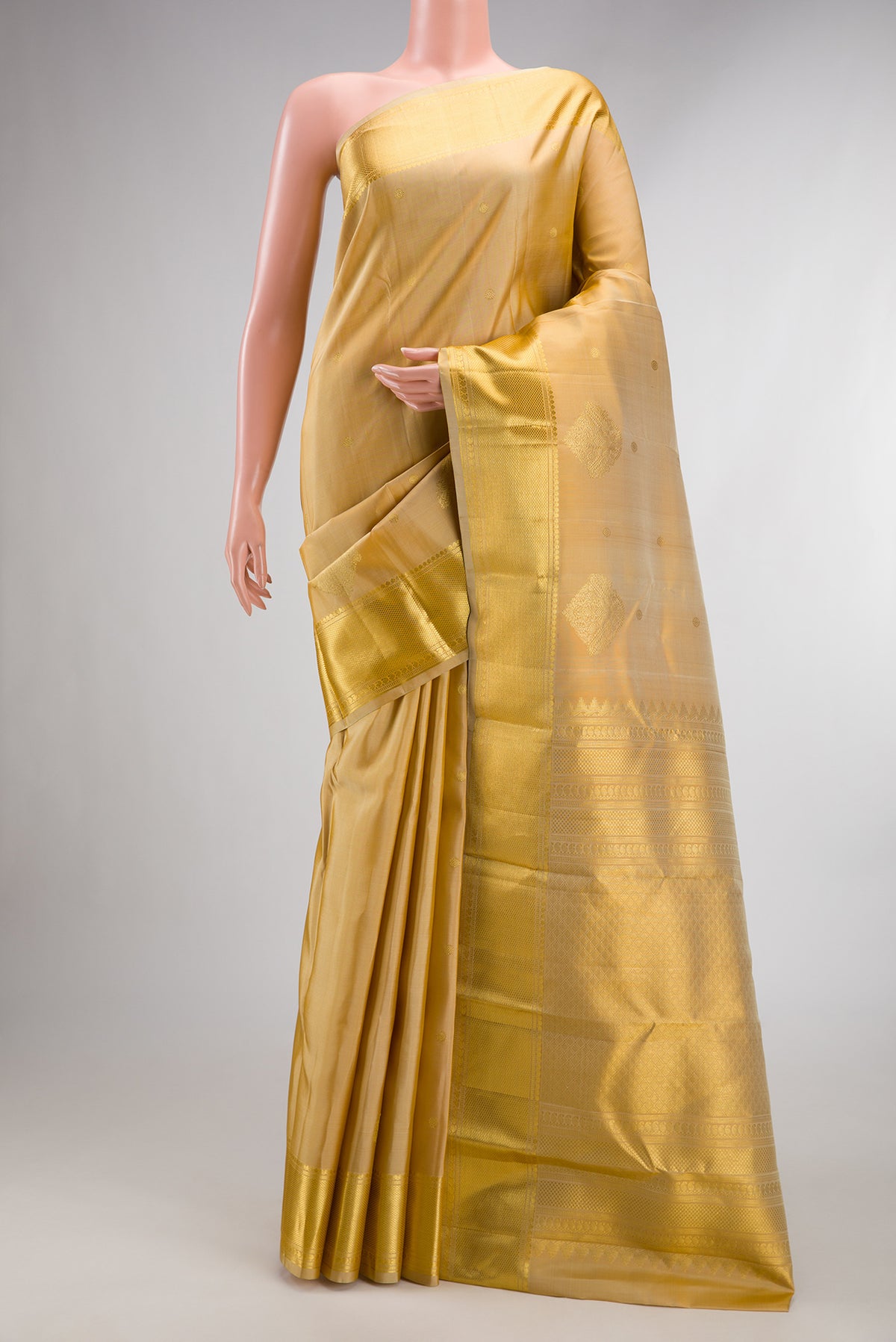 Pure Silk Sandal Kanchipuram Saree with Zari Butta on the body and Zari Border.  displayed on a mannequin