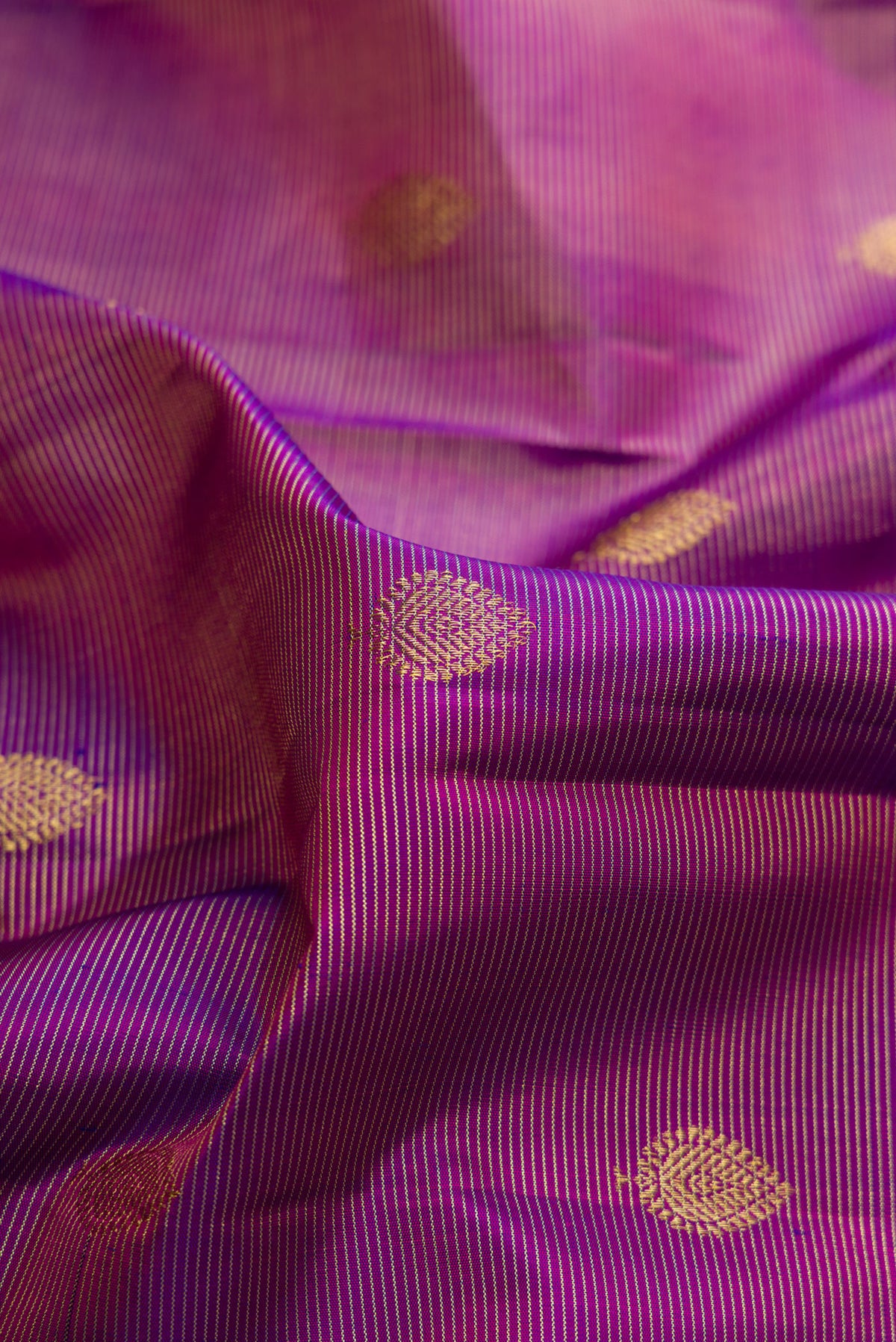 Close up of Pure Silk Purple Dual Tone Kanjivaram Saree with Stripes on the body and Zari Border.  displaying folds