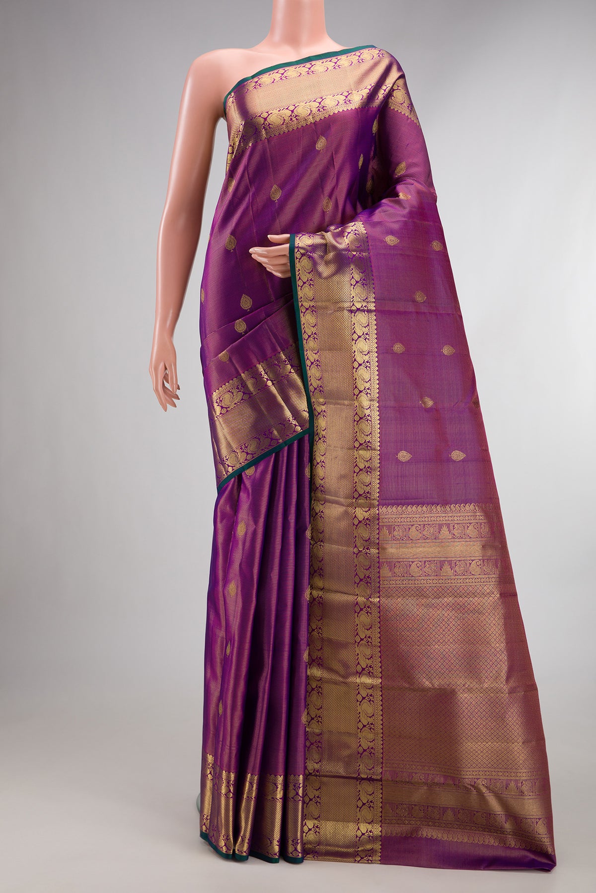 Pure Silk Purple Dual Tone Kanjivaram Saree with Stripes on the body and Zari Border.  displayed on a mannequin