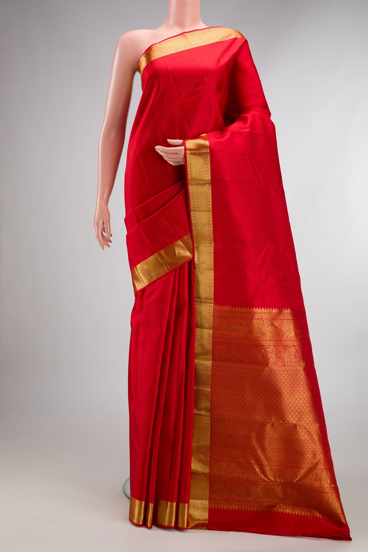 Pure Silk Red Kanchipuram Saree with Checked design on the body and Zari Border.  displayed on a mannequin