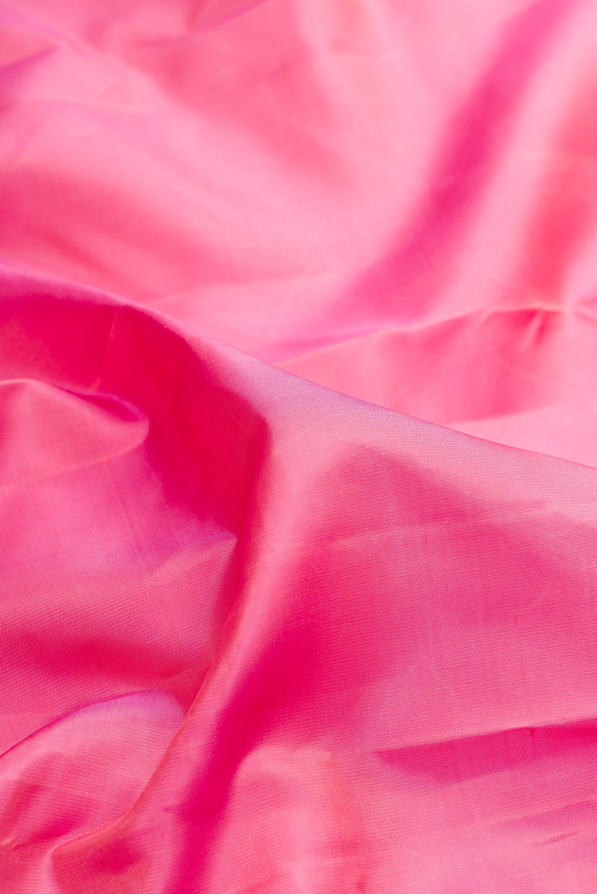 Close up of Pure Silk Pink Kanchipuram Saree with Plain Body and Temple Border.  displaying folds