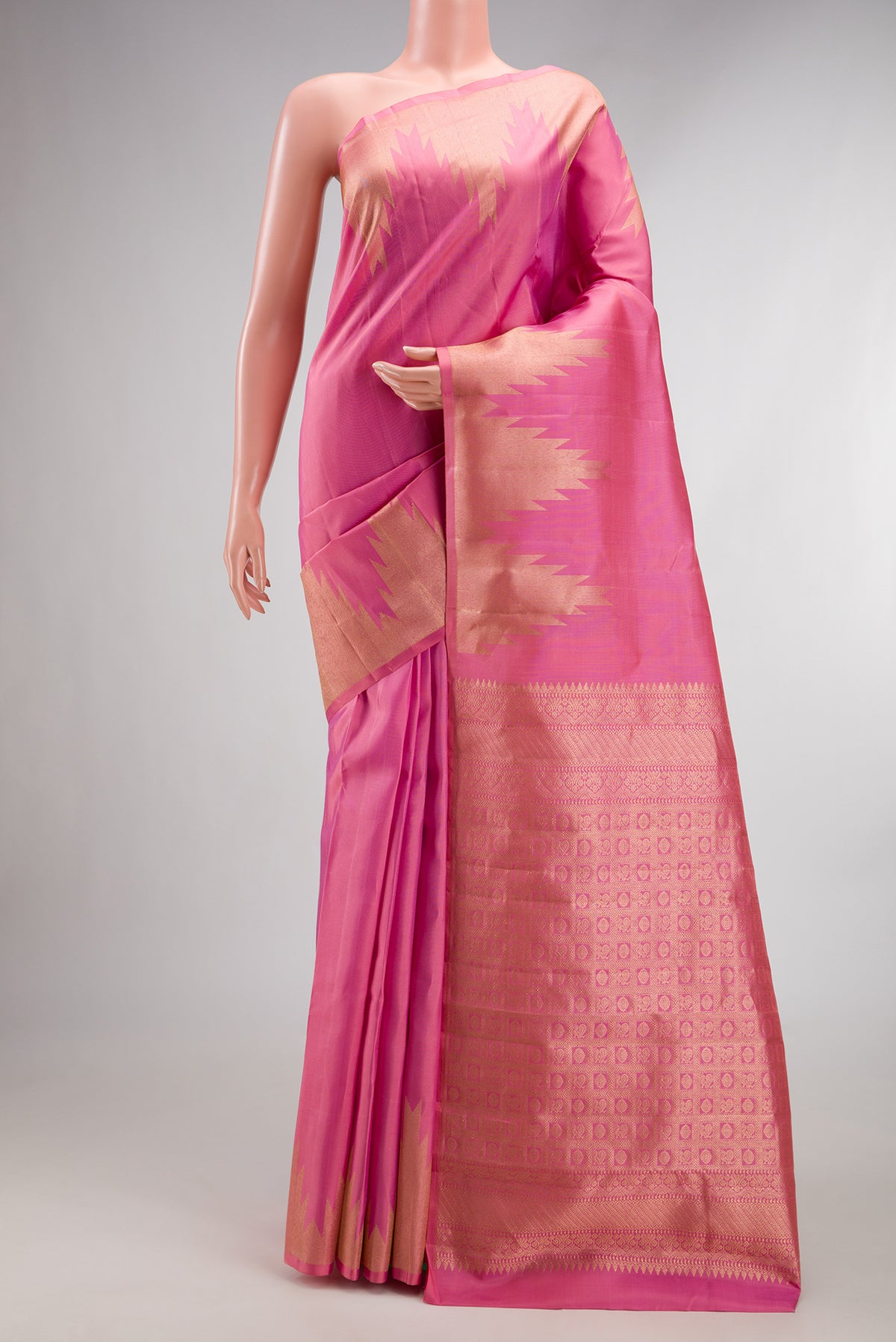 Pure Silk Pink Kanchipuram Saree with Plain Body and Temple Border.  displayed on a mannequin