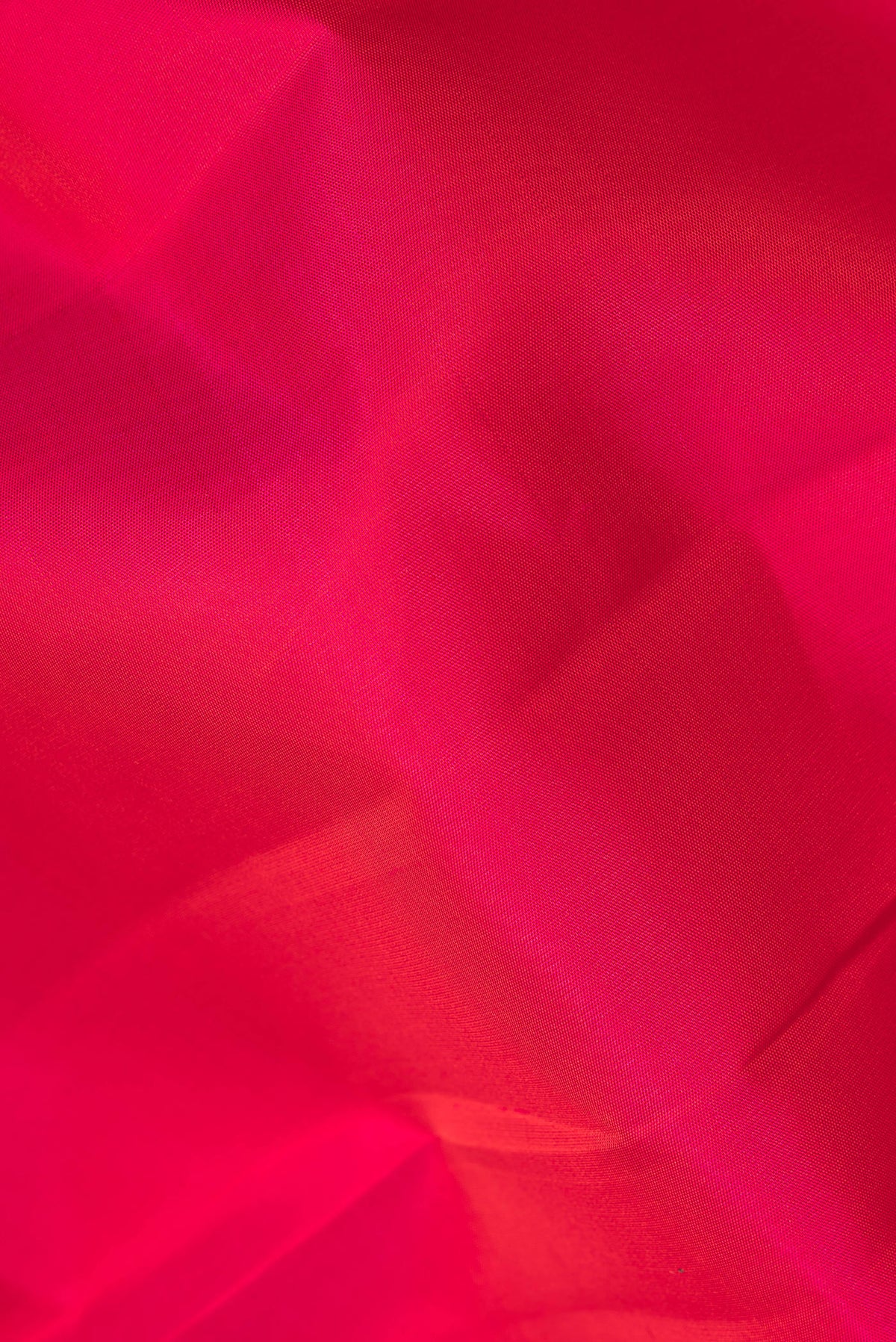 Close up of Pure Silk Dark Pink Dual Tone Kanchipuram Saree with Plain Body and Temple Border.  displaying folds
