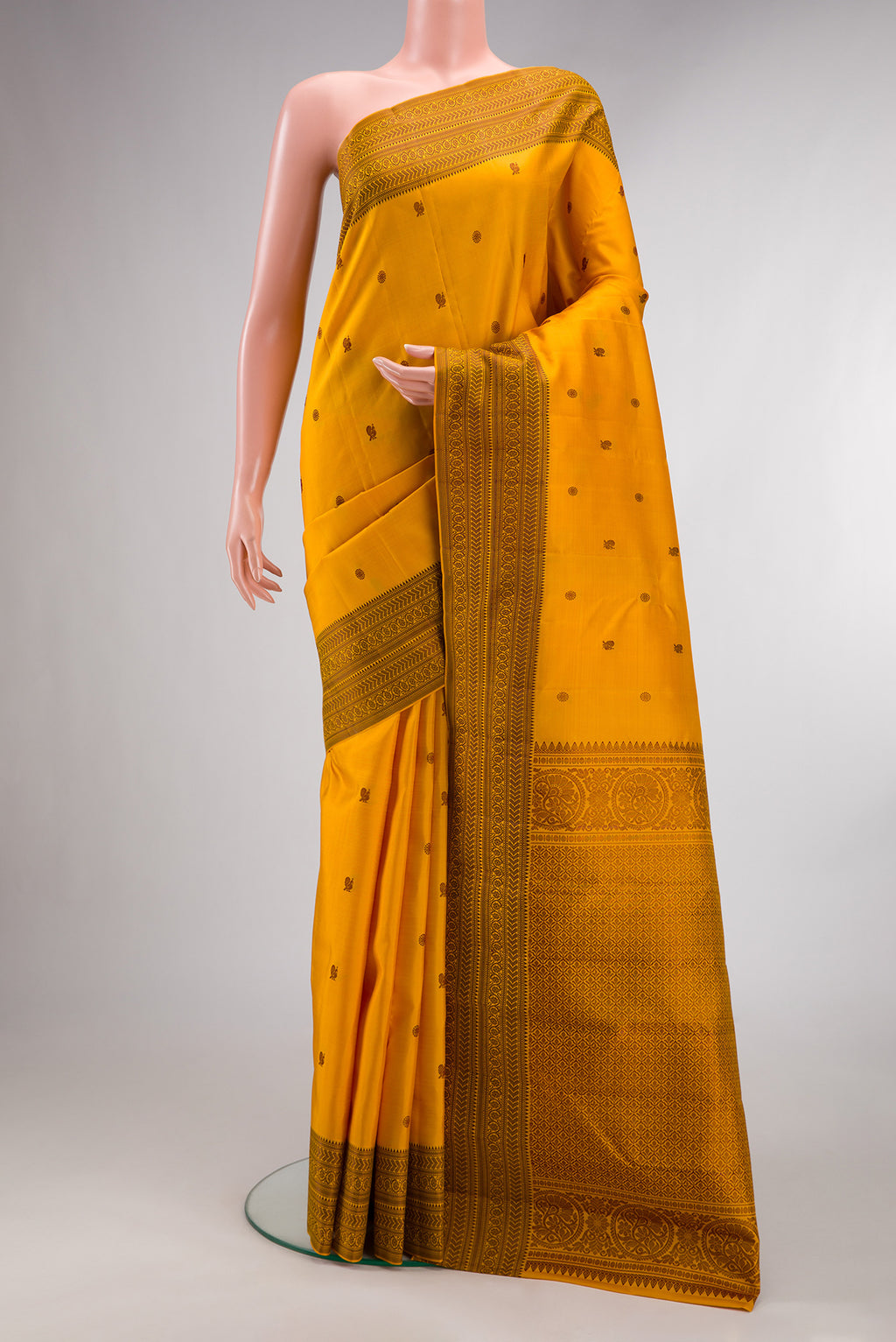 Pure Silk Mustard Kanchipuram Saree with Thread Butta on the body and Thread Border.  displayed on a mannequin