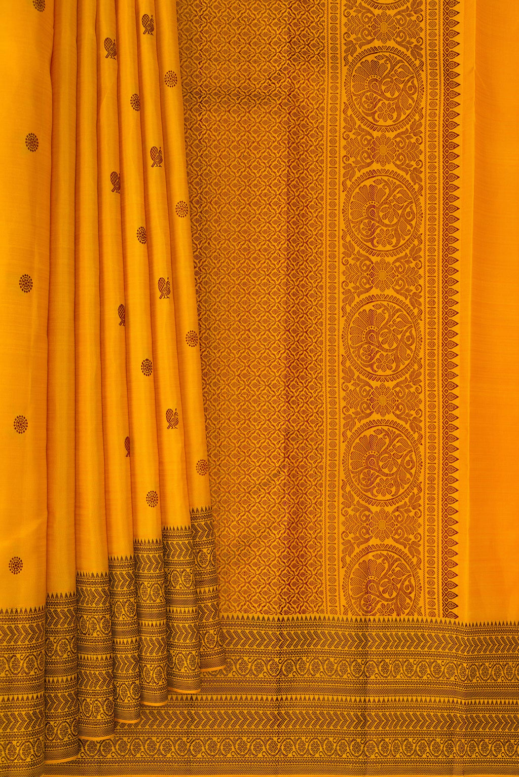 Pleats and pallu of Pure Silk Mustard Kanchipuram Saree with Thread Butta on the body and Thread Border. 
