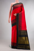 Pure Silk Pure Zari Brick Orange Kanjivaram Saree with Thread Butta on the body and Thread Border.  displayed on a mannequin