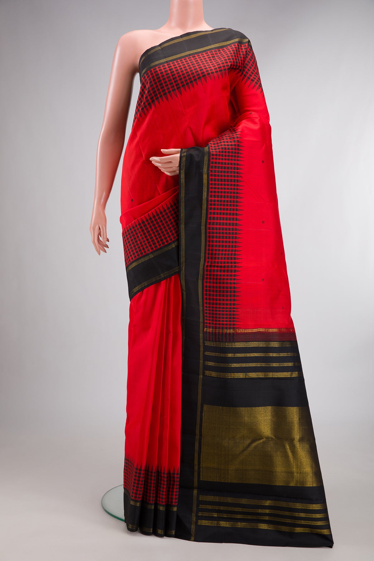 Pure Silk Pure Zari Brick Orange Kanjivaram Saree with Thread Butta on the body and Thread Border.  displayed on a mannequin