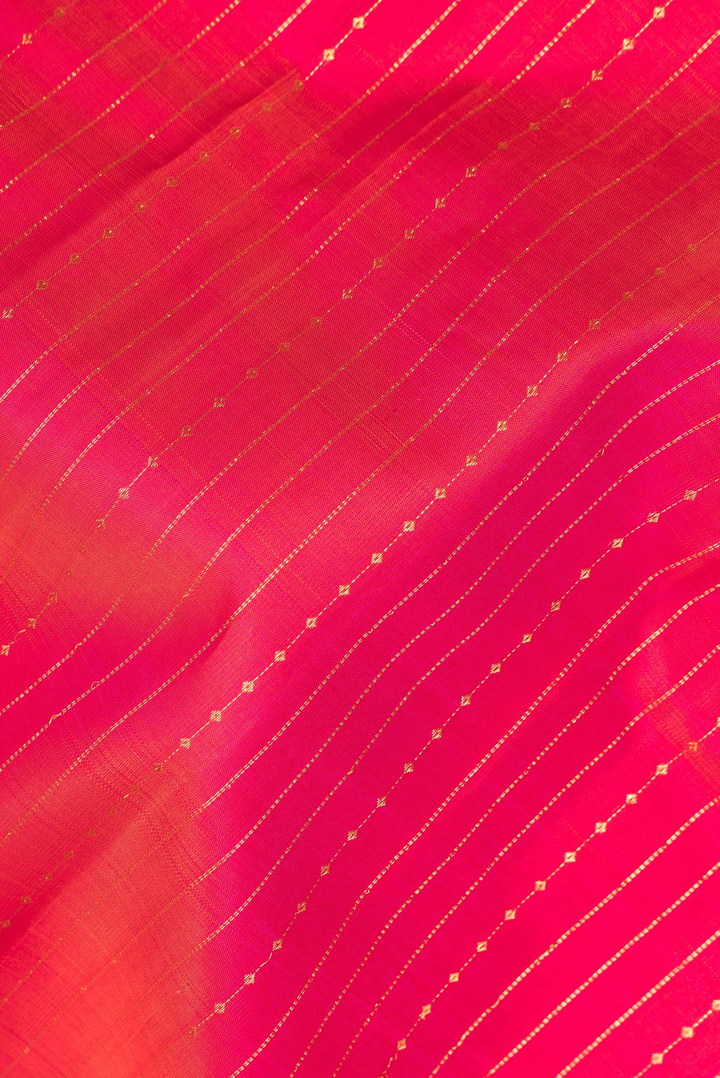 Close up of Pure Silk Dark Pink Dual Tone Kanchipuram Saree with Stripes on the body and Zari Border.  displaying folds