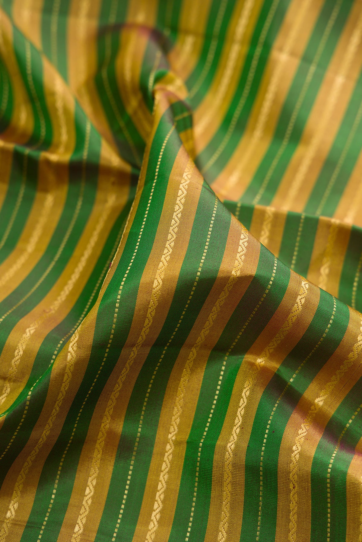 Close up of Pure Silk Multi Color Kanchipuram Saree with Stripes on the body and Zari Border.  displaying folds