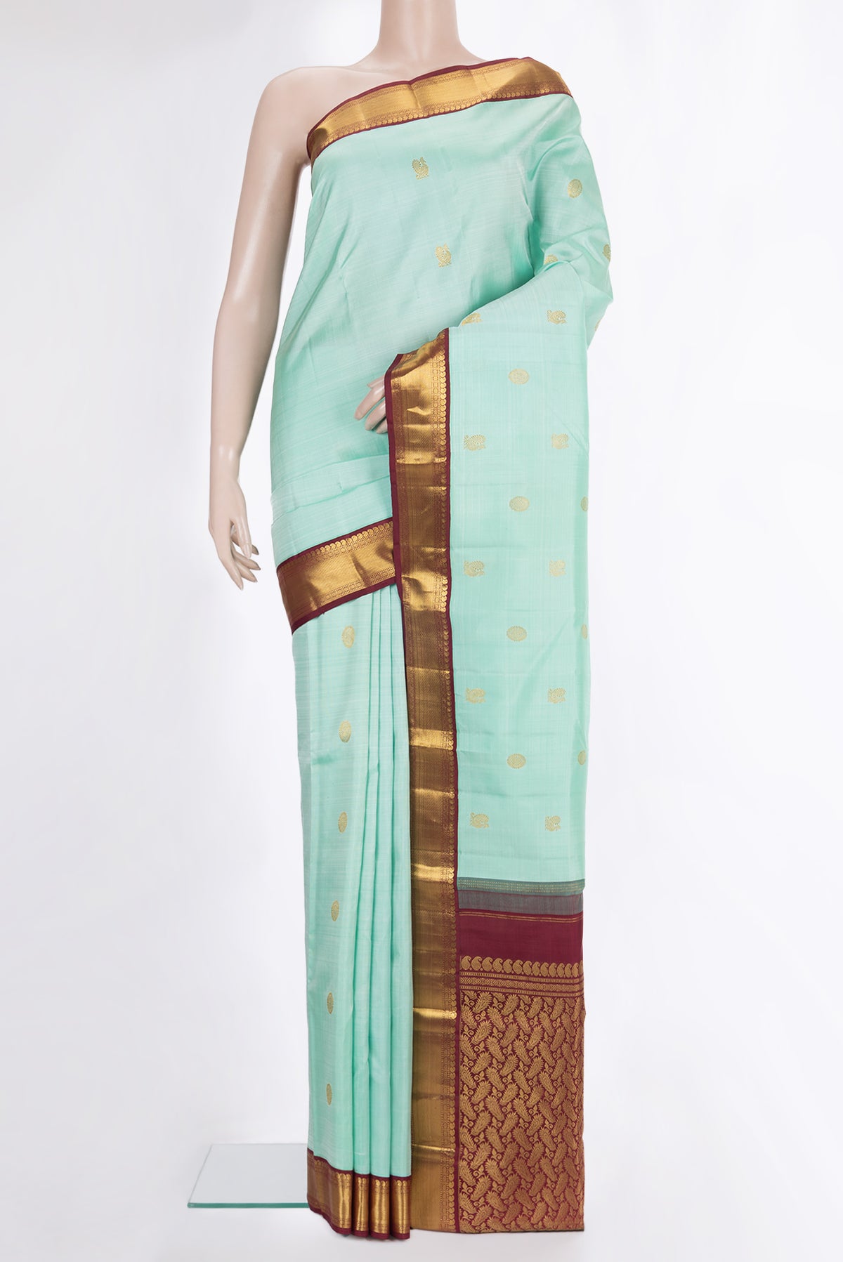 Pure Silk Pista Green Dual Tone Kanjivaram Saree with Zari Butta on the body and Zari Border.  displayed on a mannequin