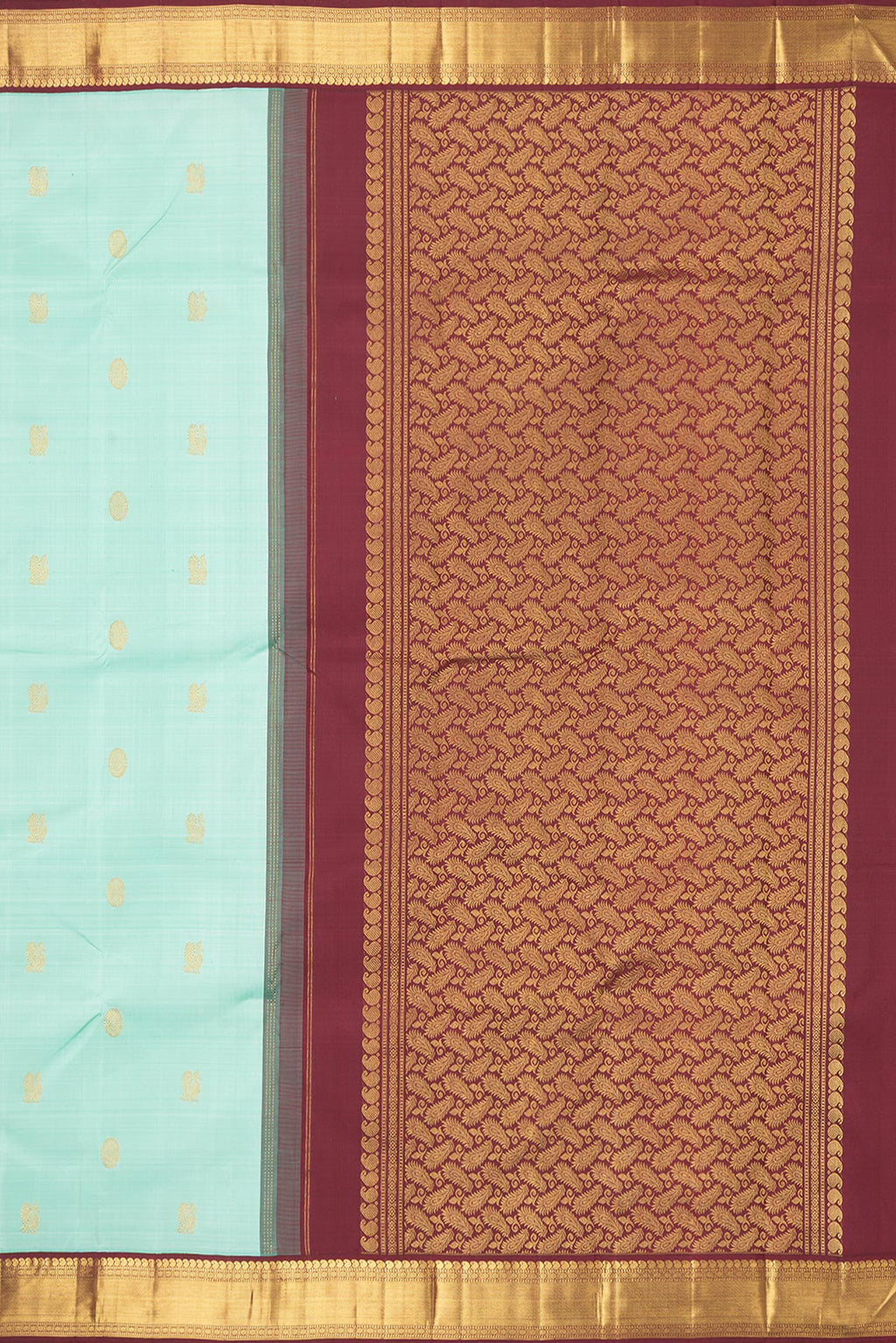 Close up image of the pallu of Pure Silk Pista Green Dual Tone Kanjivaram Saree with Zari Butta on the body and Zari Border. 