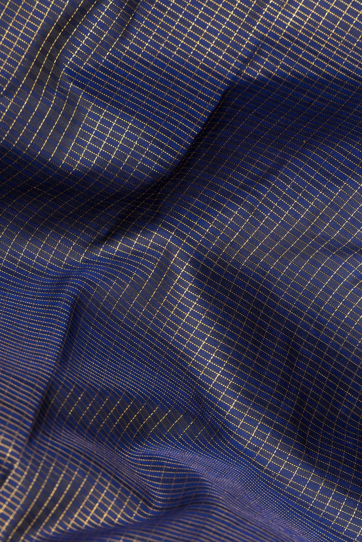 Close up of Pure Silk Navy Blue Dual Tone Kanjivaram Saree with Checked design on the body and Zari Border.  displaying folds