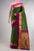 Pure Silk Bottle Green Kanchipuram Saree with Checked design on the body and Zari Border.  displayed on a mannequin