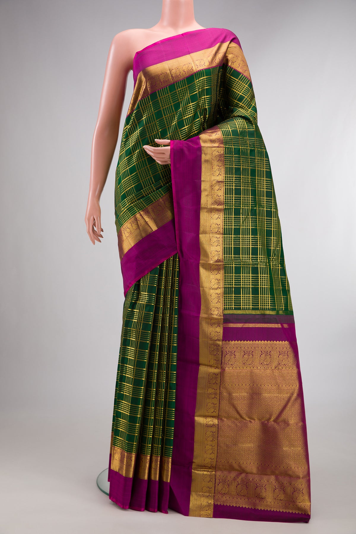 Pure Silk Bottle Green Kanchipuram Saree with Checked design on the body and Zari Border.  displayed on a mannequin
