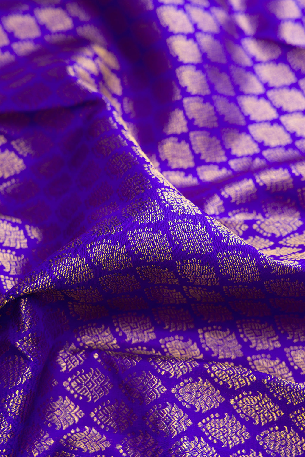Close up of Pure Silk Royal Blue Kanchipuram Saree with Zari Brocade on the body and Zari Border.  displaying folds