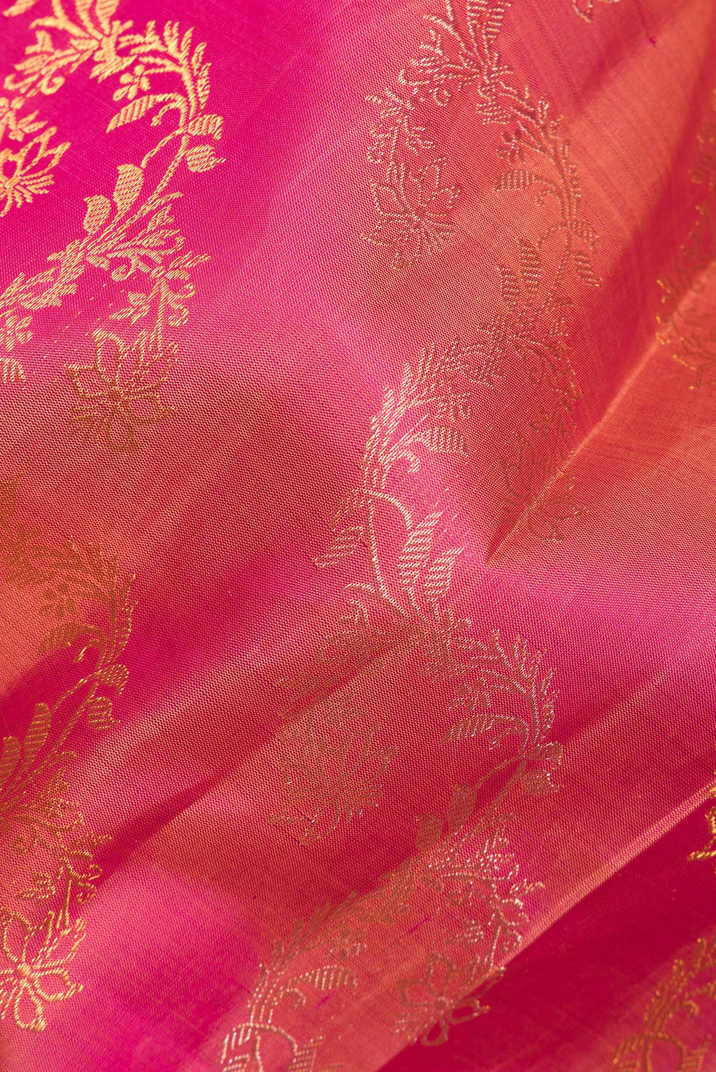 Close up of Pure Silk Pink Dual Tone Kanchipuram Saree with Zari Butta on the body and Zari Border.  displaying folds