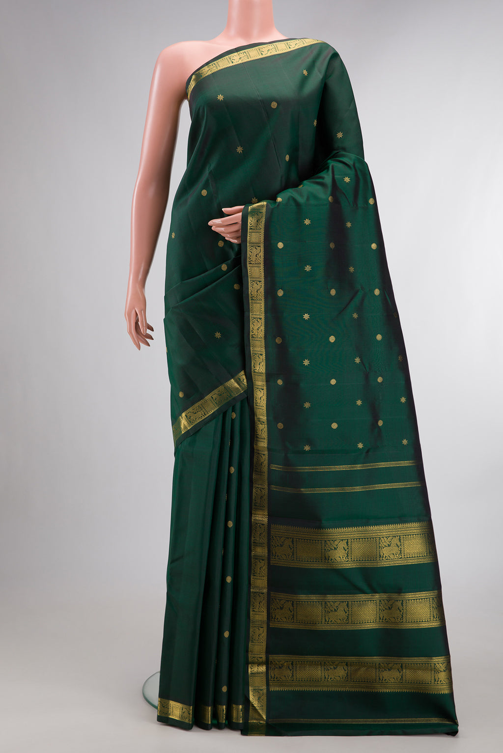 Pure Silk Pure Zari Bottle Green Kanchipuram Saree with Zari Butta on the body and Zari Border.  displayed on a mannequin
