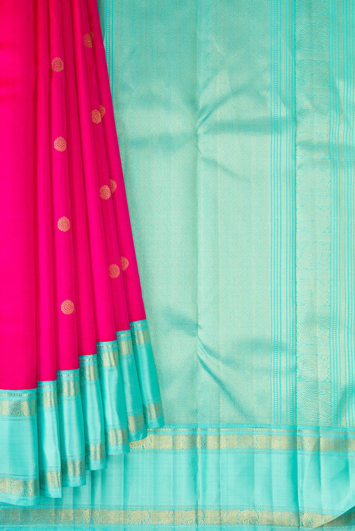 Pleats and pallu of Pure Silk Pure Zari Rani Pink Kanjivaram Saree with Zari Butta on the body and Zari Border. 