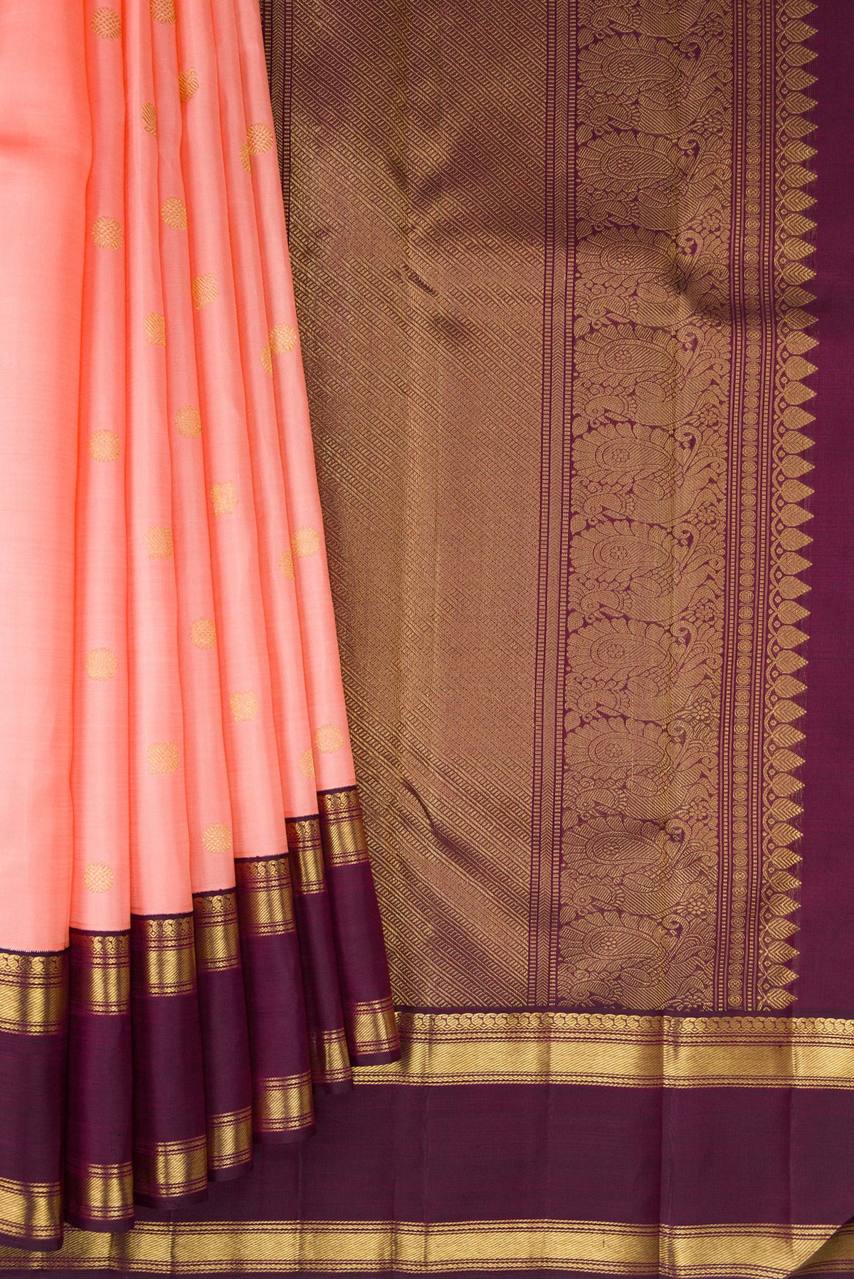 Pleats and pallu of Pure Silk Pure Zari Peach Kanjivaram Saree with Zari Butta on the body and Zari Border. 