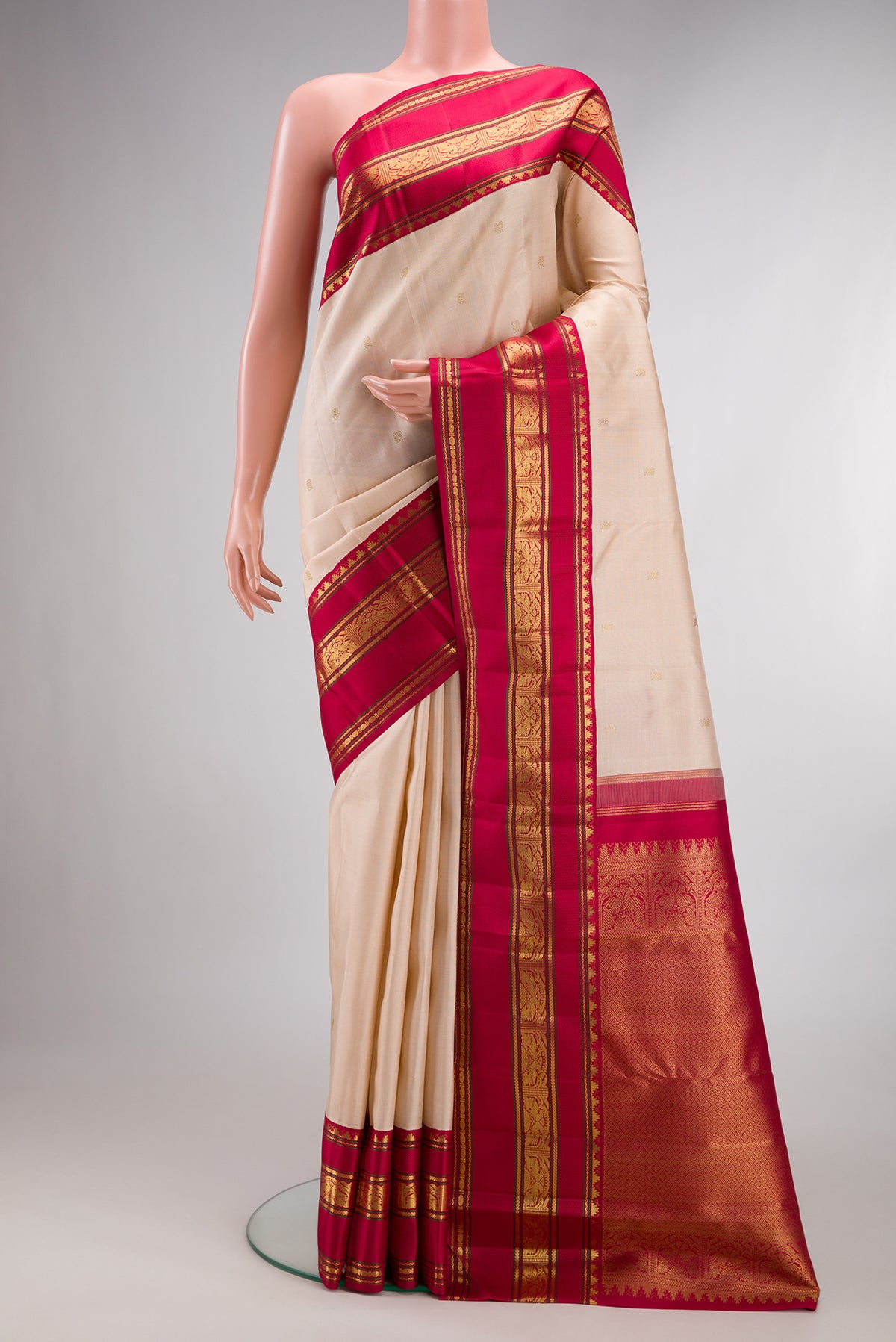 Pure Silk Pure Zari Cream Dual Tone Kanjivaram Saree with Zari Butta on the body and Zari Border.  displayed on a mannequin