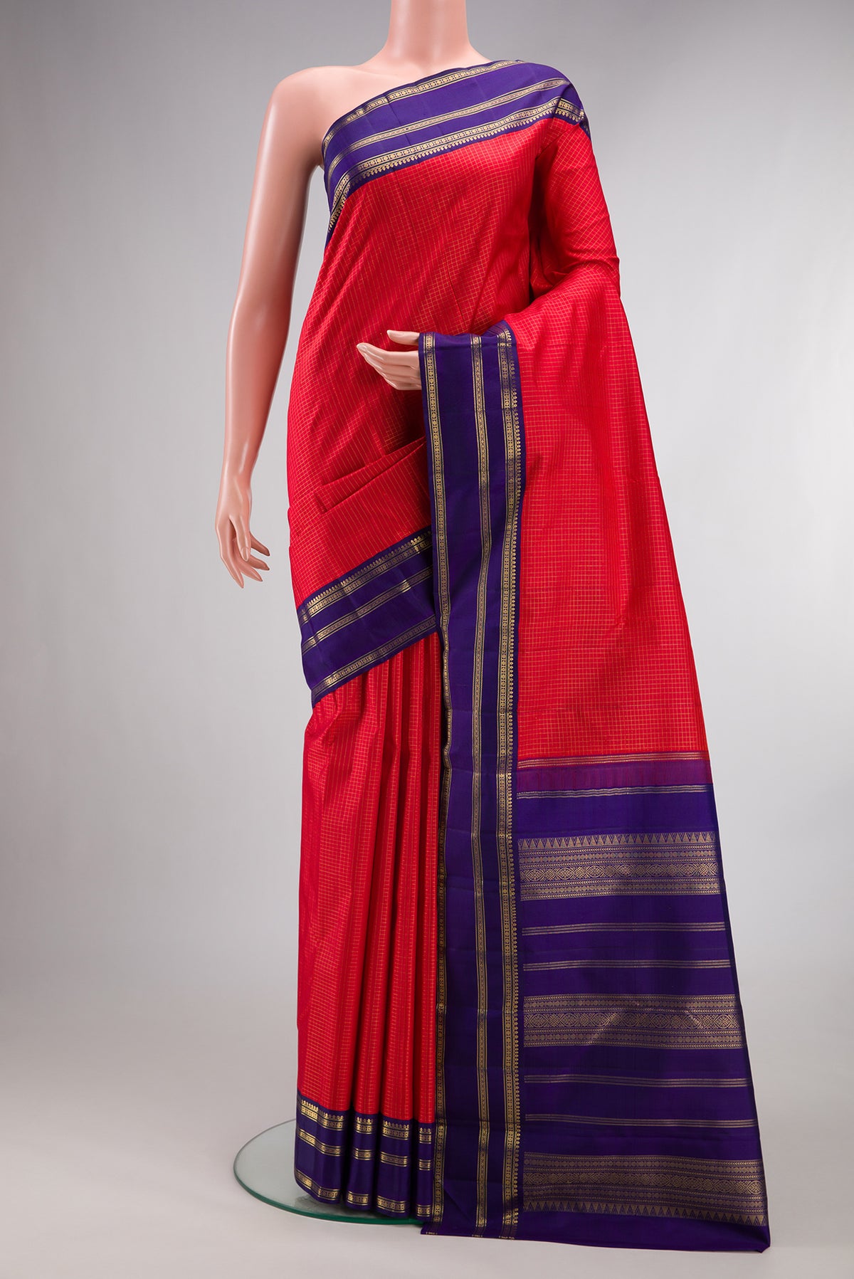 Pure Silk Pure Zari Red Kanjivaram Saree with Checked design on the body and Zari Border.  displayed on a mannequin