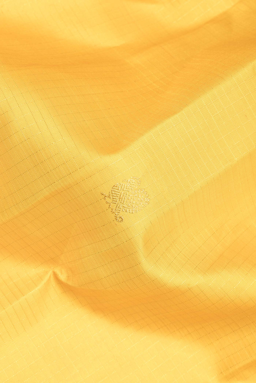 Close up of Pure Silk Yellow Dual Tone Kanchipuram Saree with Checked design on the body and Zari Border.  displaying folds