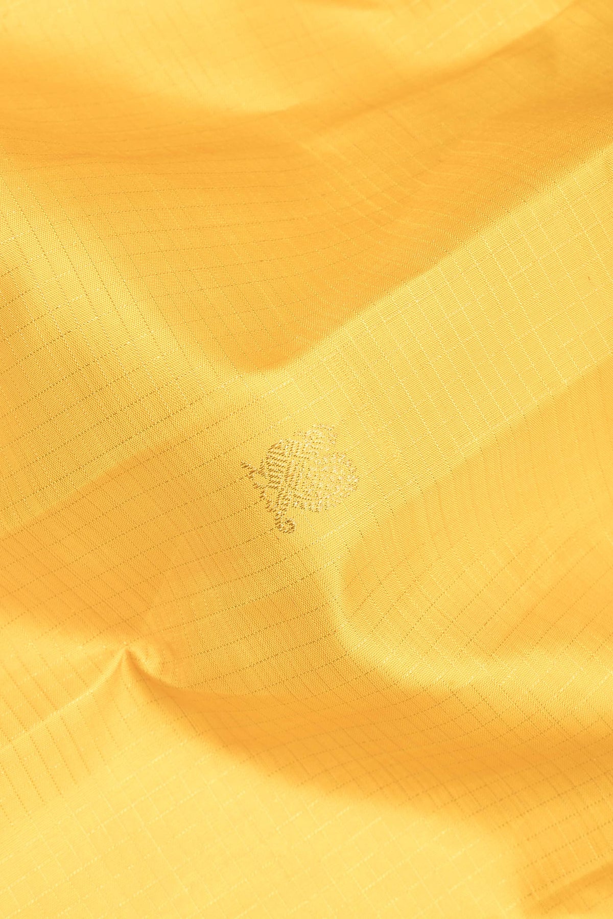 Close up of Pure Silk Yellow Dual Tone Kanchipuram Saree with Checked design on the body and Zari Border.  displaying folds