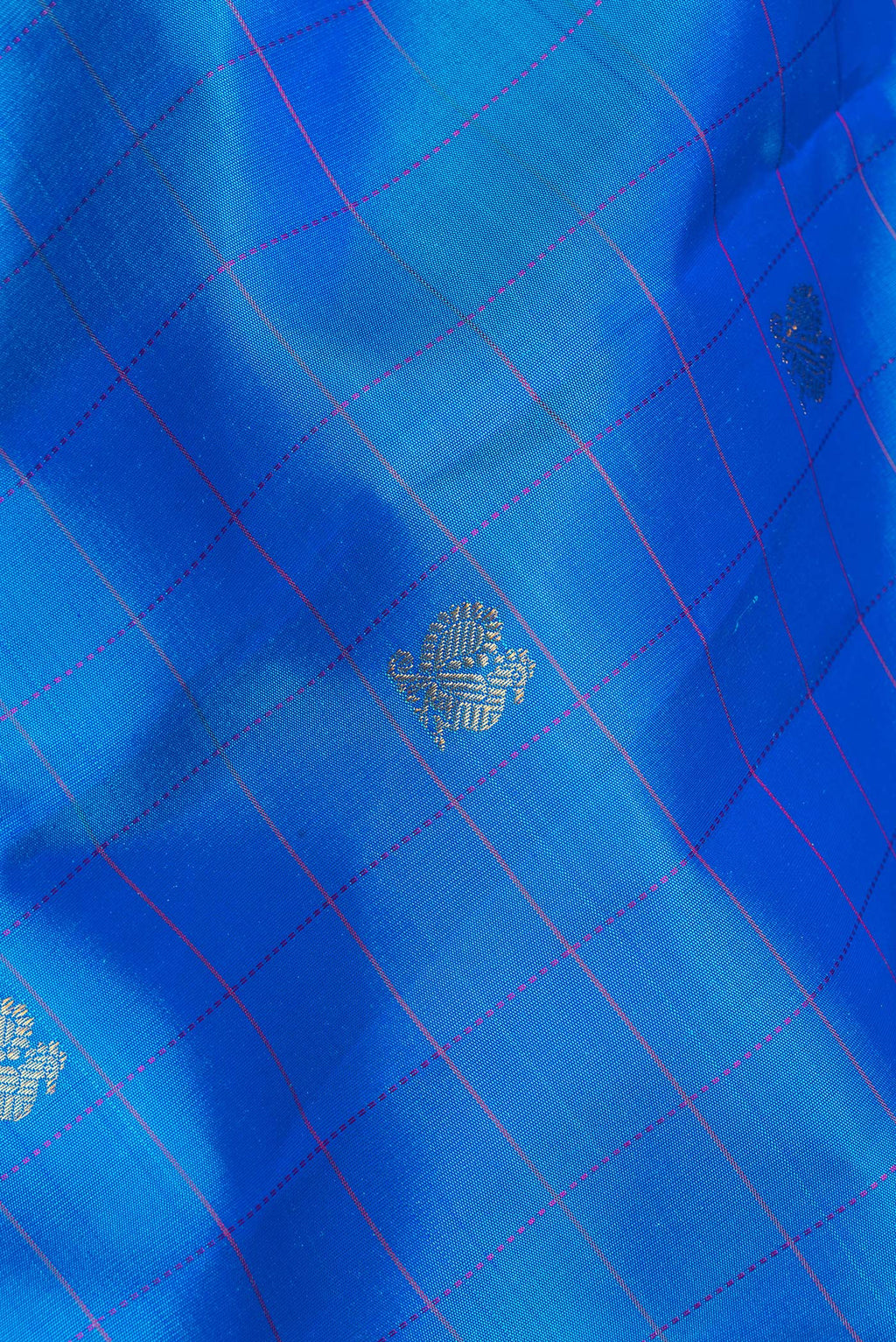 Close up of Pure Silk Royal Blue Dual Tone Kanchipuram Saree with Checked design on the body and Zari Border.  displaying folds