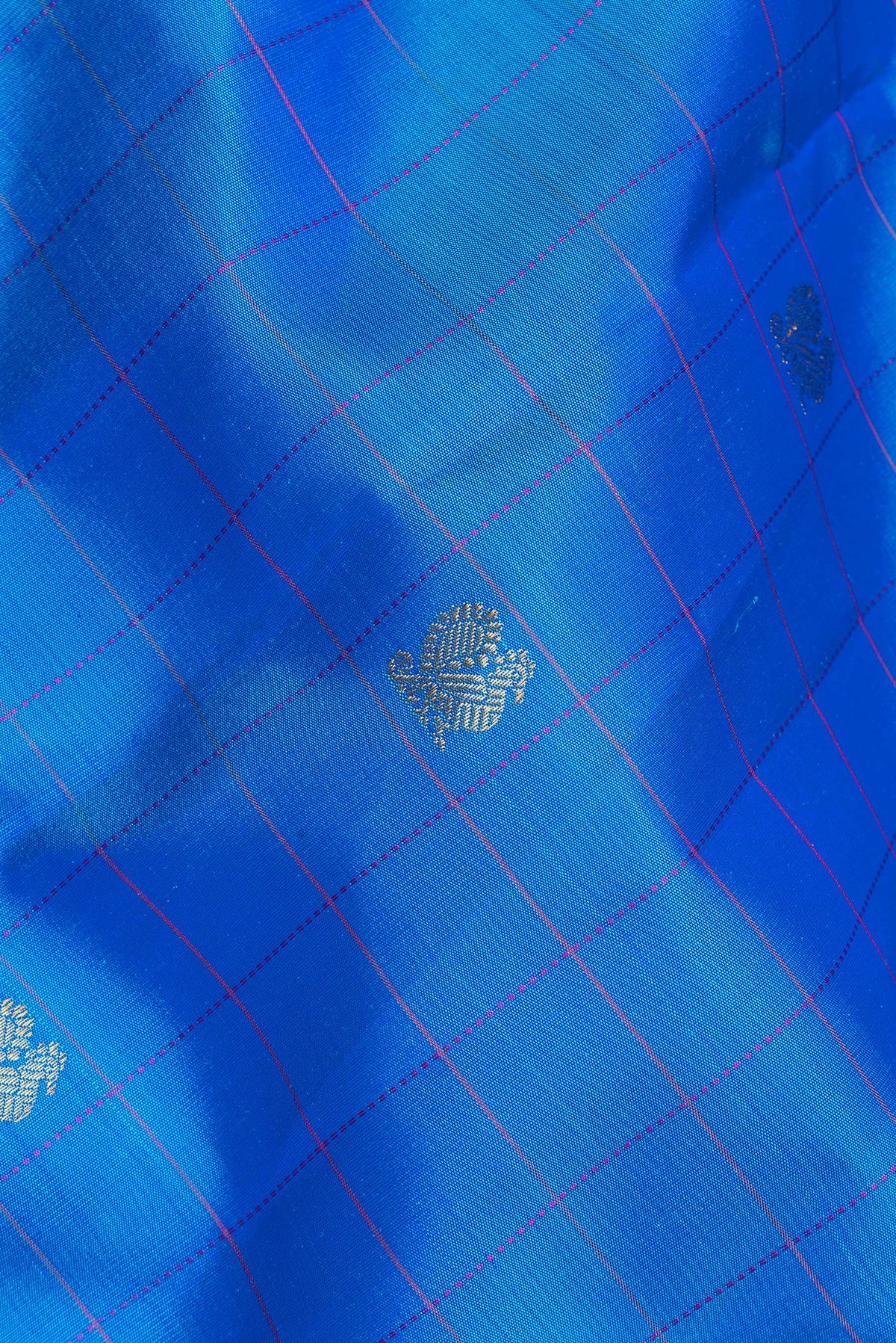 Close up of Pure Silk Royal Blue Dual Tone Kanchipuram Saree with Checked design on the body and Zari Border.  displaying folds