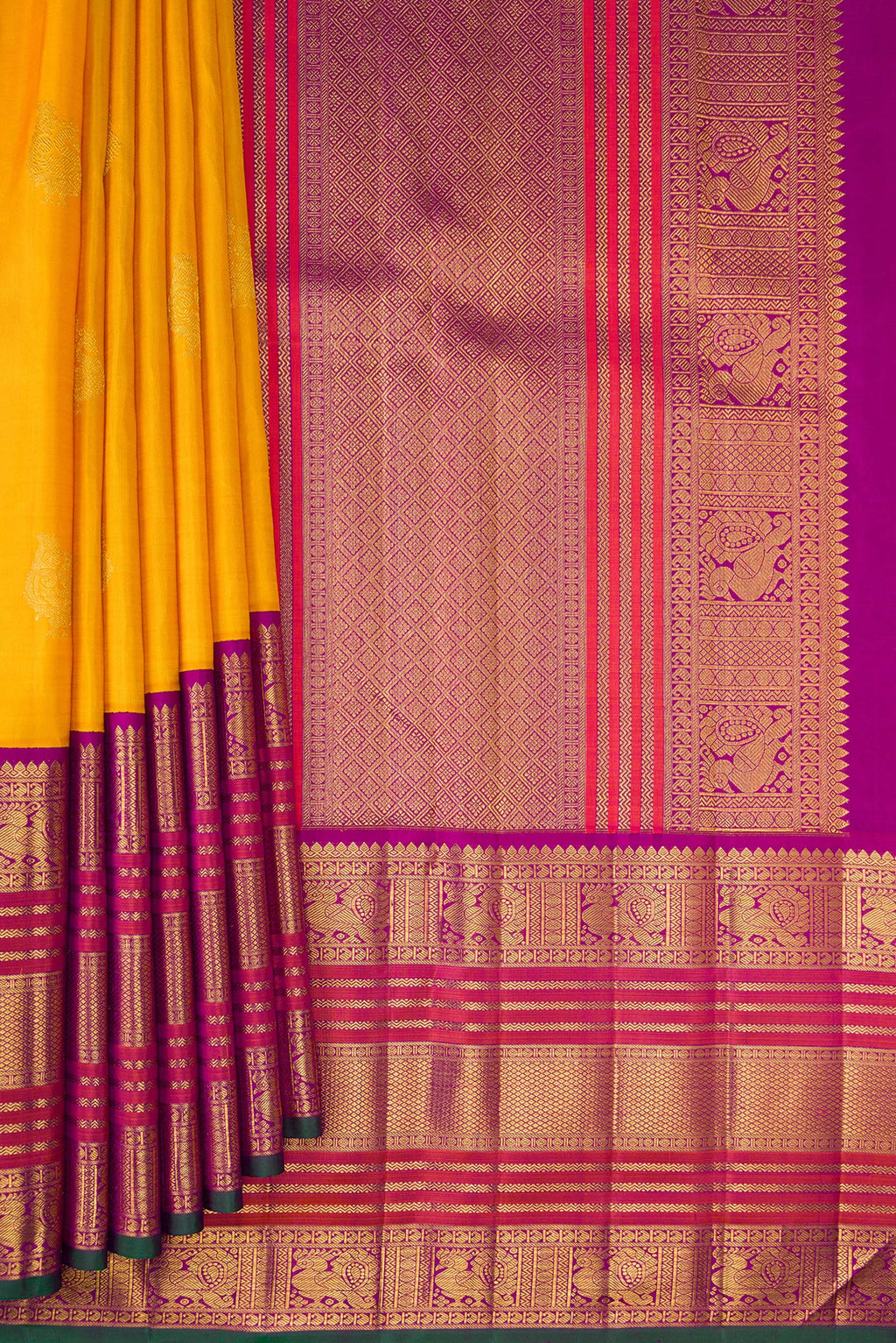 Pleats and pallu of Pure Silk Pure Zari Mustard Kanchipuram Saree with Zari Butta on the body and Zari Border. 