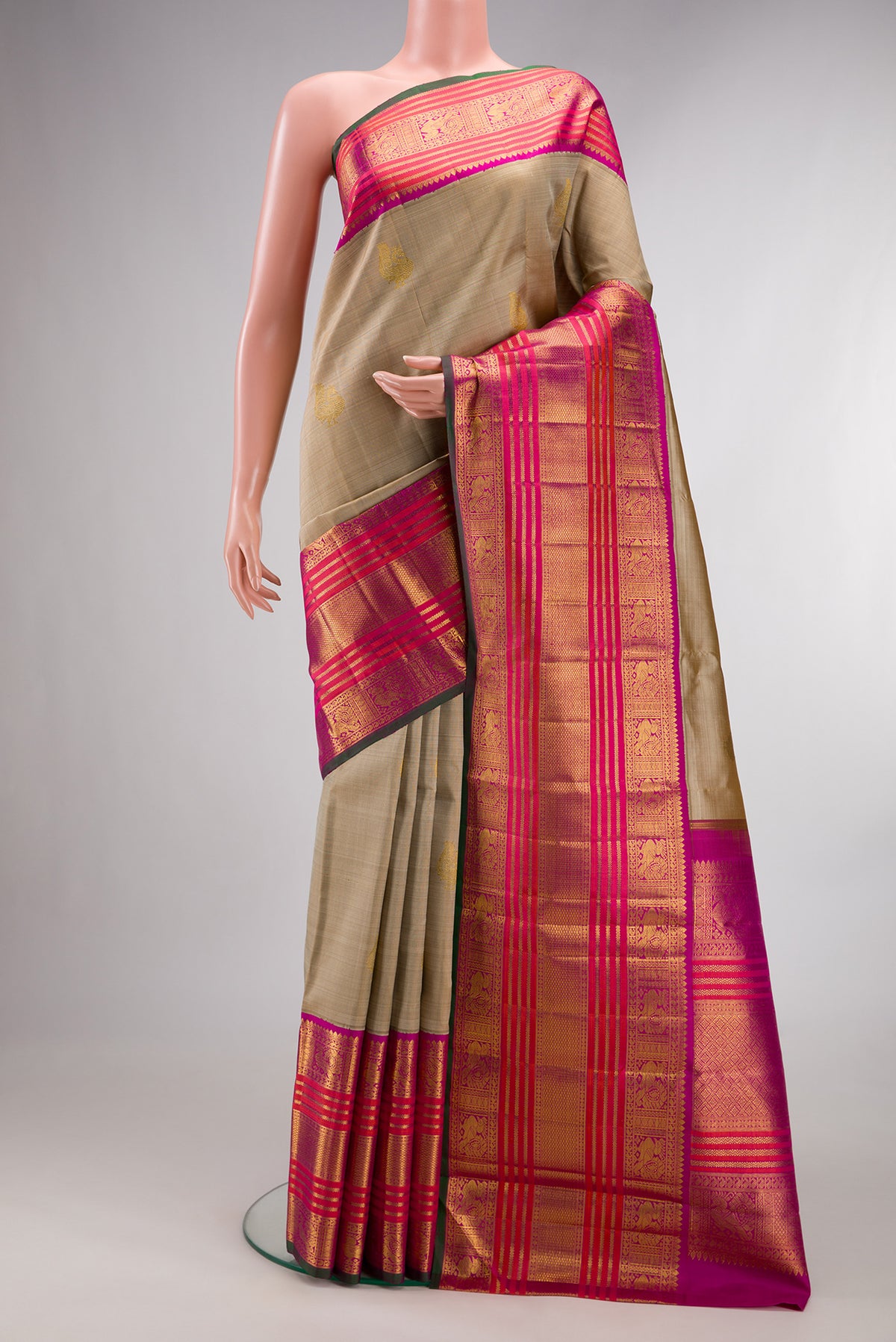 Pure Silk Pure Zari Dark Beige Kanchipuram Saree with Zari Butta on the body and Zari Border.  displayed on a mannequin