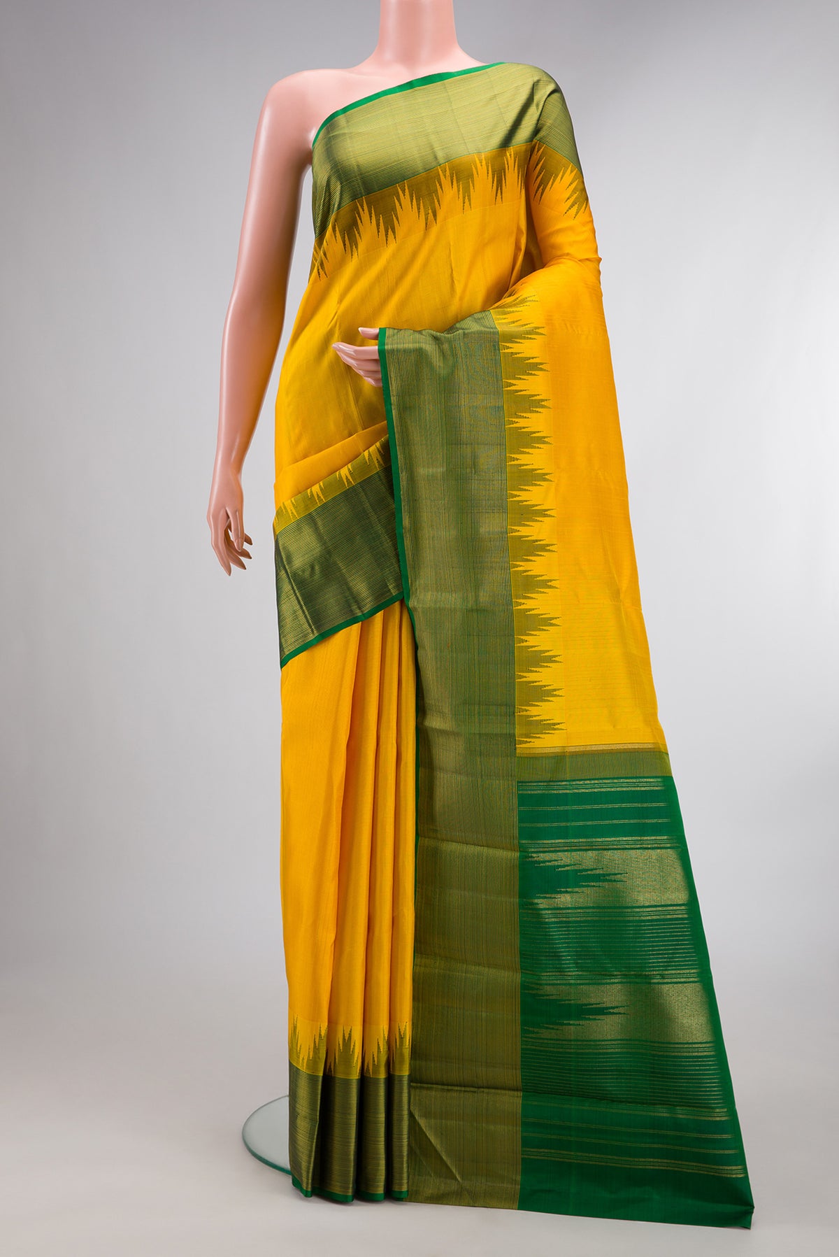 Pure Silk Yellow Kanjivaram Saree with Plain Body and Temple Border.  displayed on a mannequin