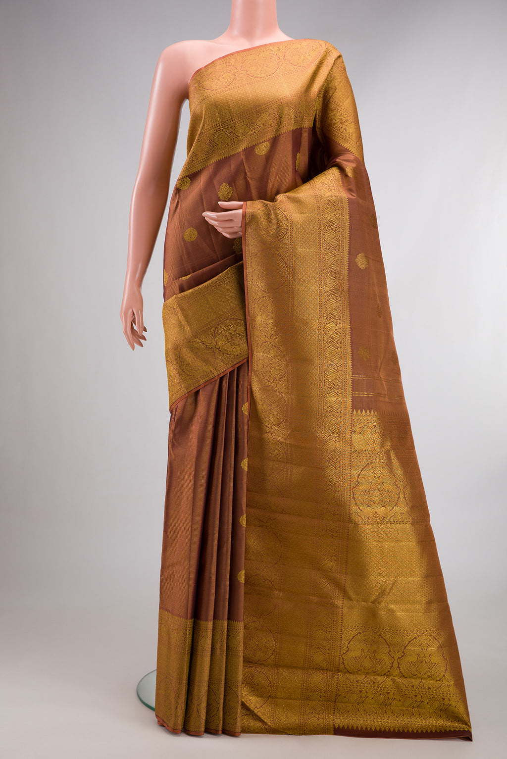 Pure Silk Brown Kanchipuram Saree with Stripes on the body and Fancy Border.  displayed on a mannequin