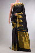Pure Silk Black Kanjivaram Saree with Zari Butta on the body and Temple Border.  displayed on a mannequin