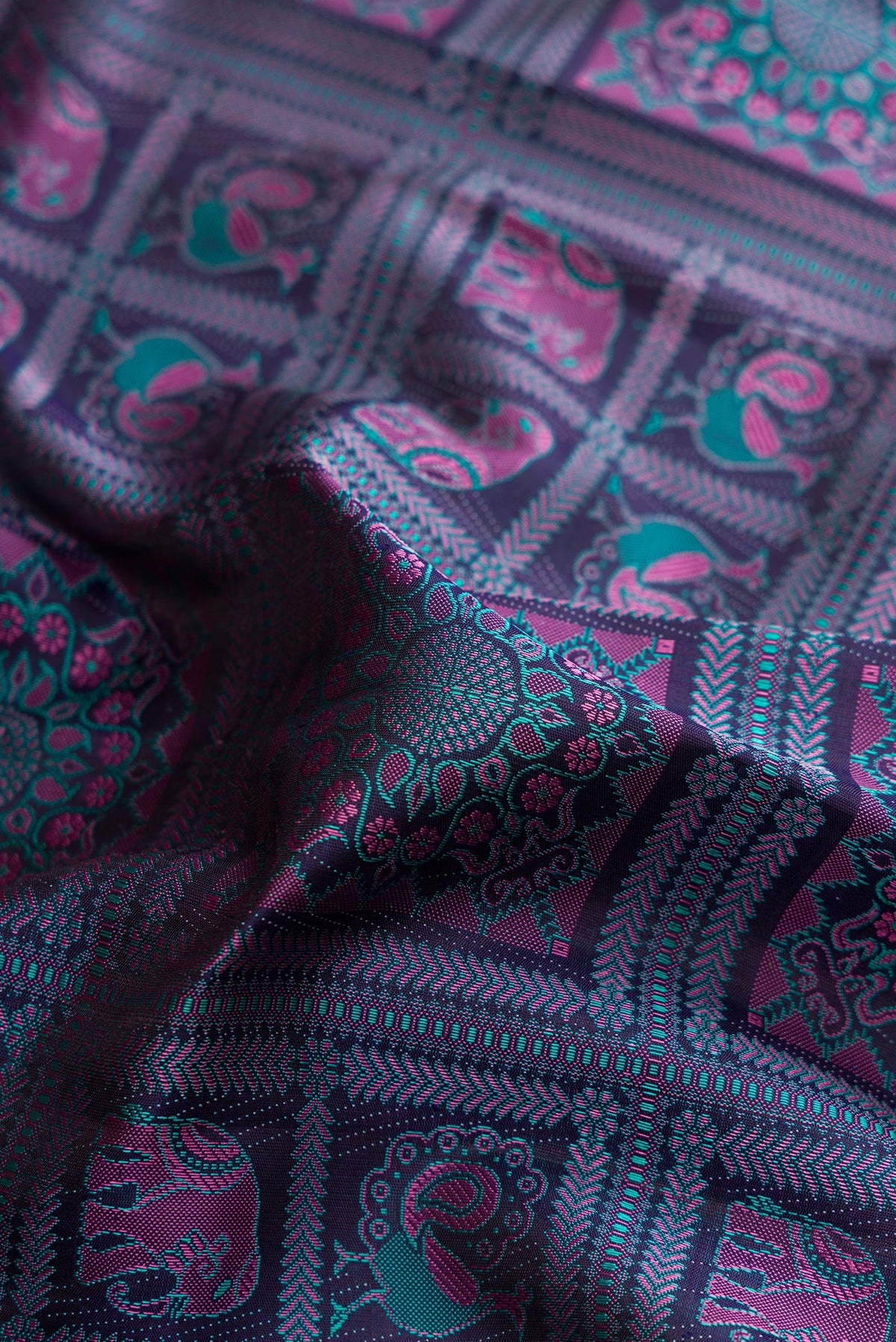 Close up of Pure Silk Navy Blue Kanjivaram Saree with Jacquard With Thread Butta on the body and Plain Border.  displaying folds