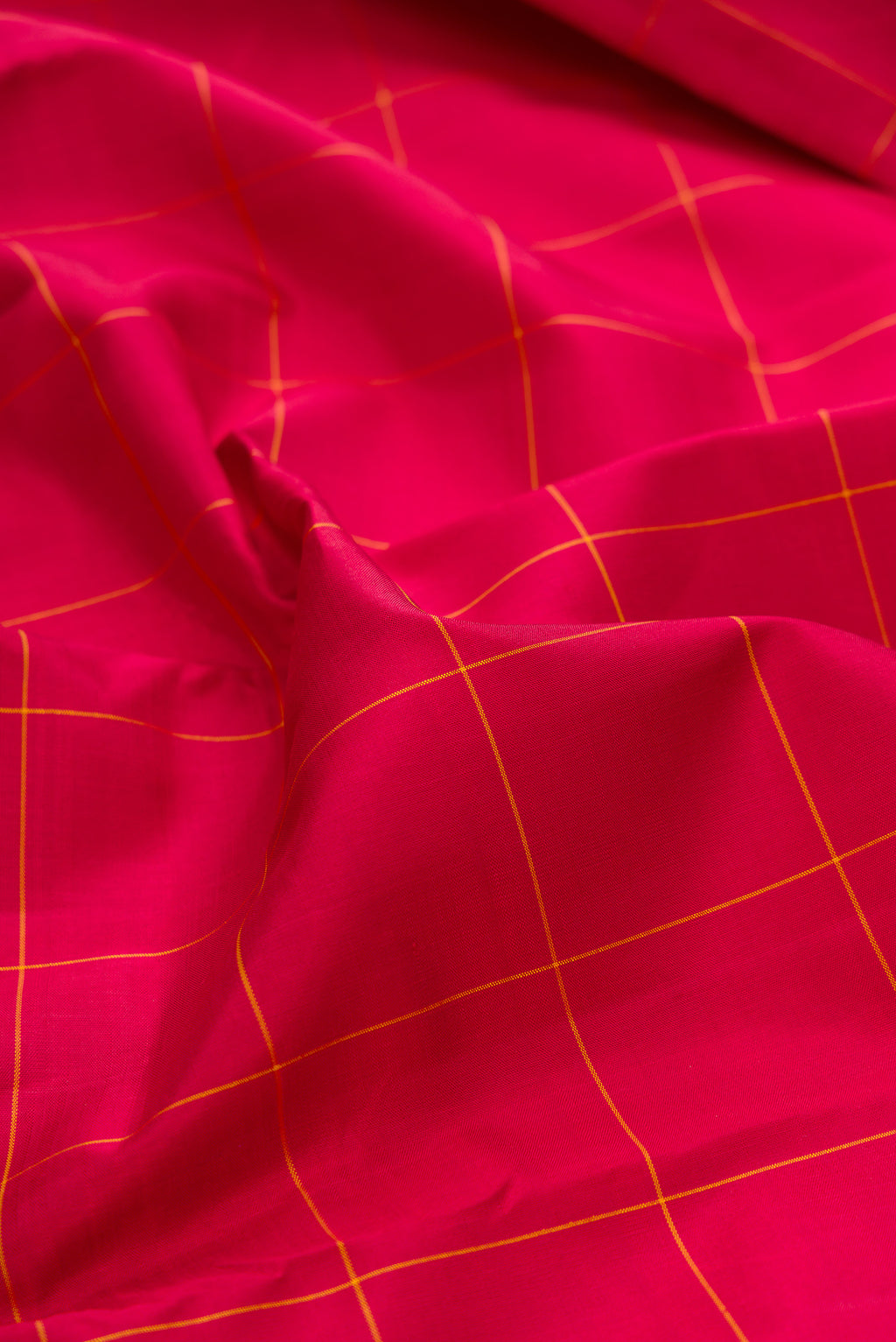 Close up of Pure Silk Red Kanjivaram Saree with Checked design on the body and Fancy Border.  displaying folds