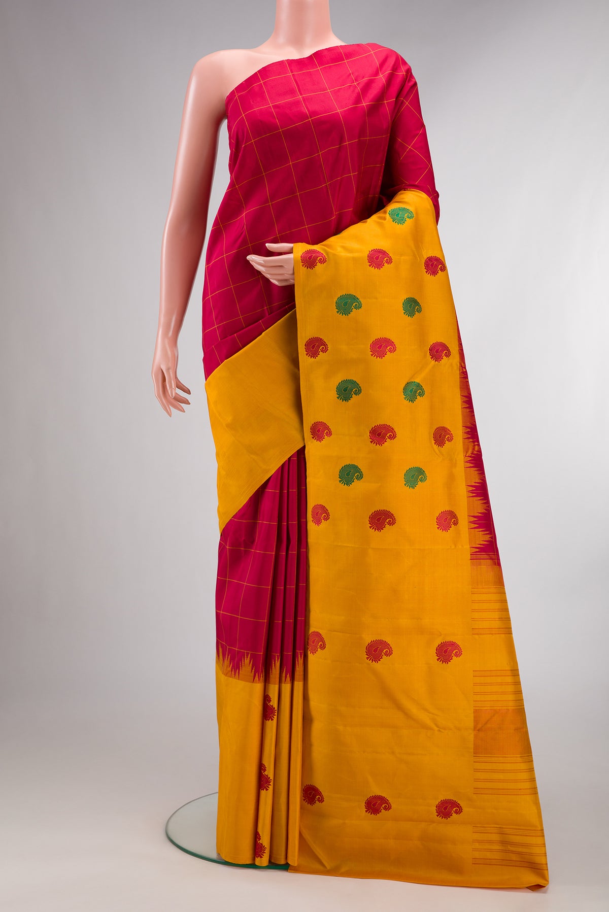Pure Silk Red Kanjivaram Saree with Checked design on the body and Fancy Border.  displayed on a mannequin