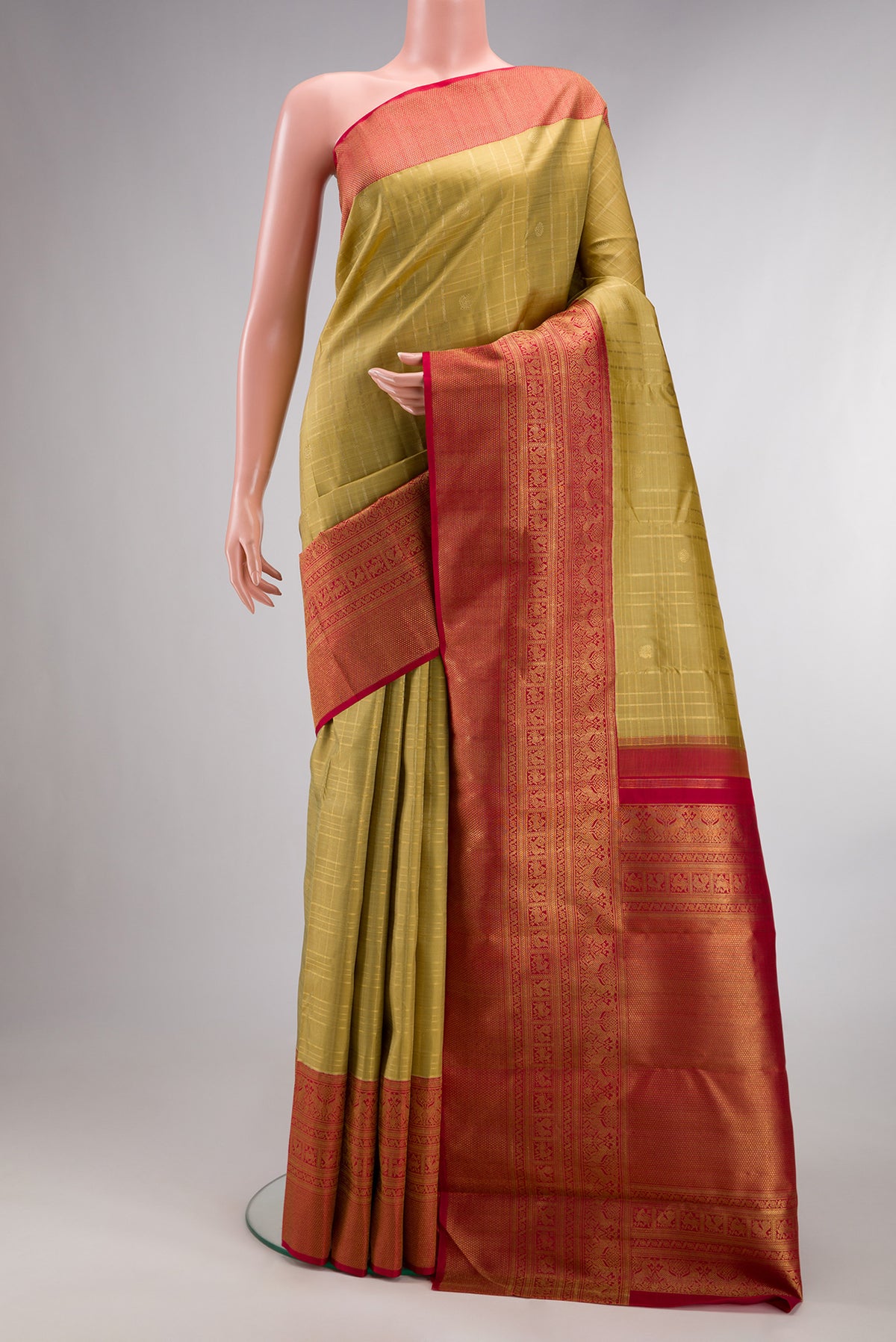 Pure Silk Pure Zari Gold Dual Tone Kanjivaram Saree with Zari Butta on the body and Zari Border.  displayed on a mannequin