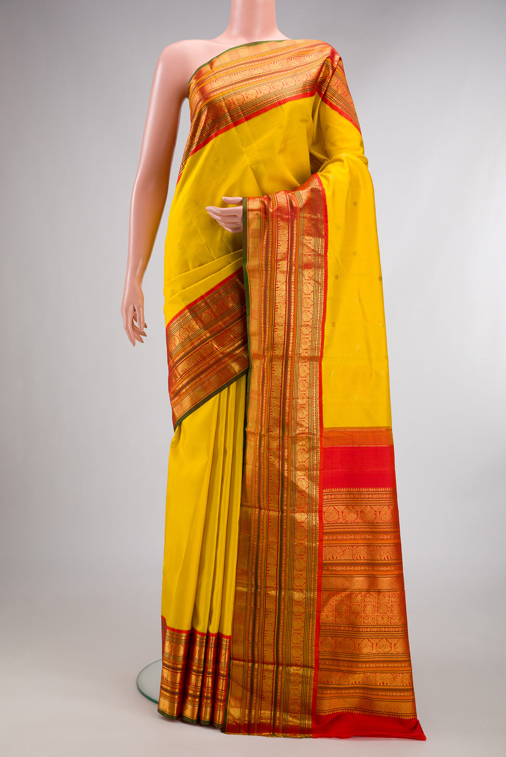 Pure Silk Yellow Kanchipuram Saree with Zari Butta on the body and Zari Border.  displayed on a mannequin