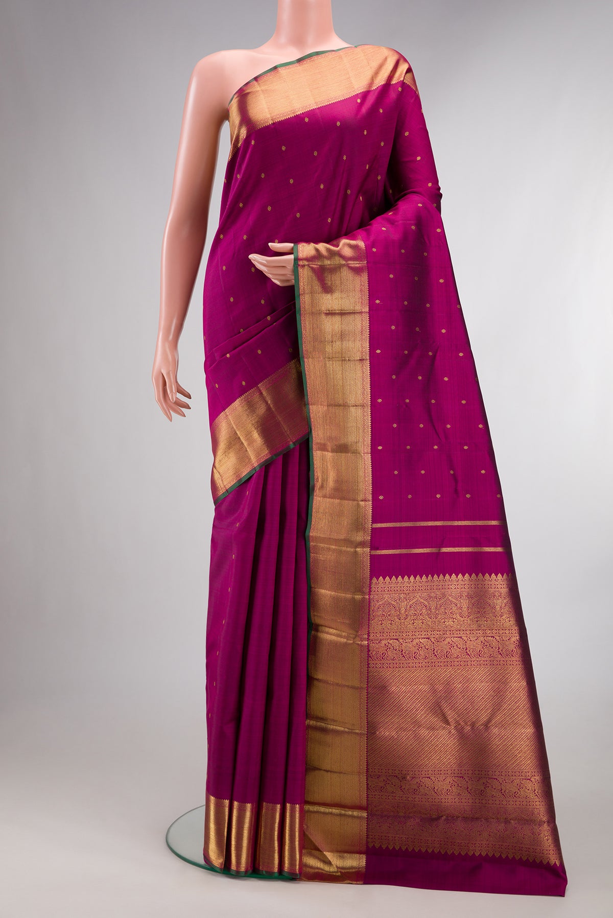 Pure Silk Pure Zari Magenta Kanjivaram Saree with Zari Butta on the body and Zari Border.  displayed on a mannequin