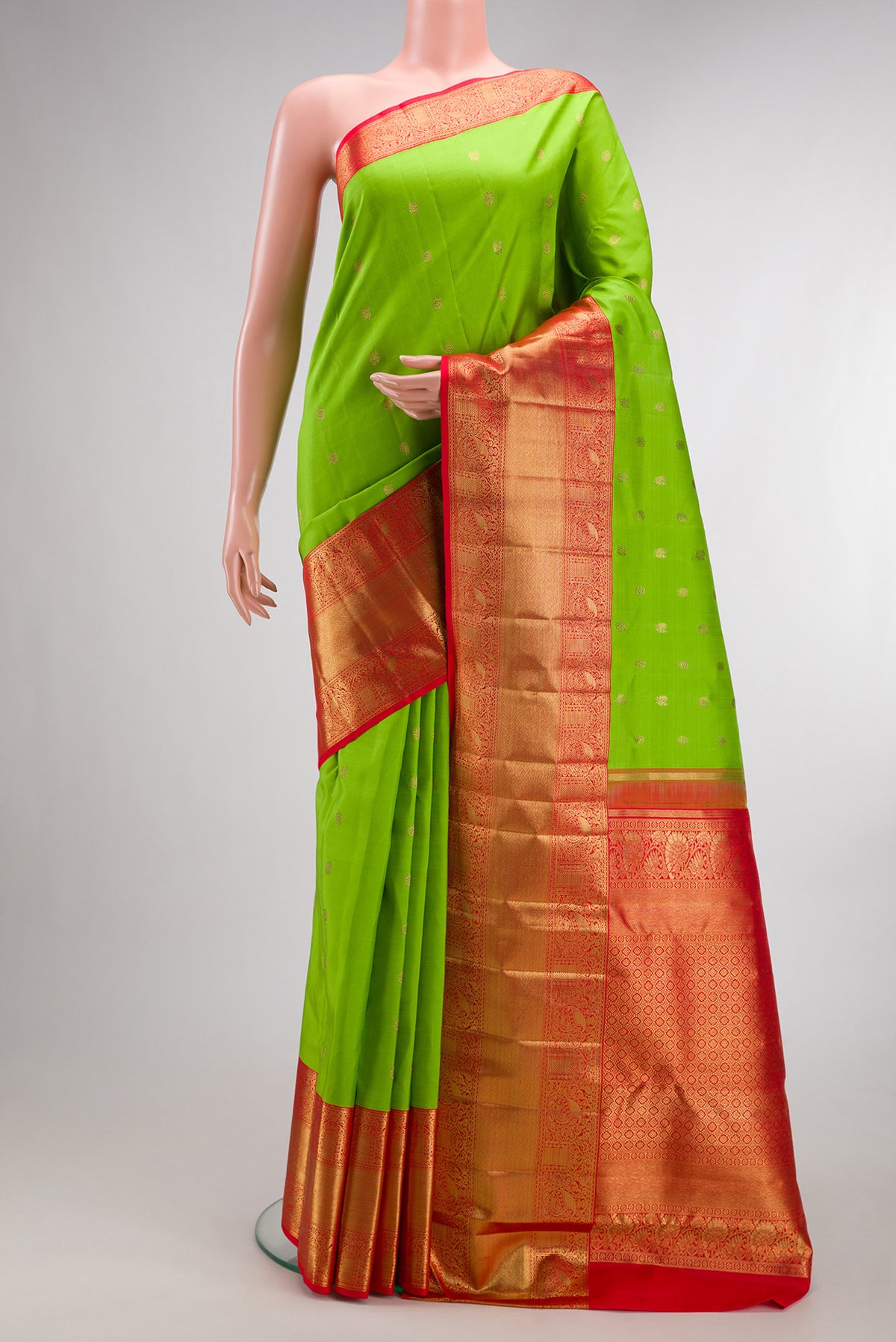 Pure Silk Pure Zari Parrot Green Dual Tone Kanjivaram Saree with Zari Butta on the body and Zari Border.  displayed on a mannequin