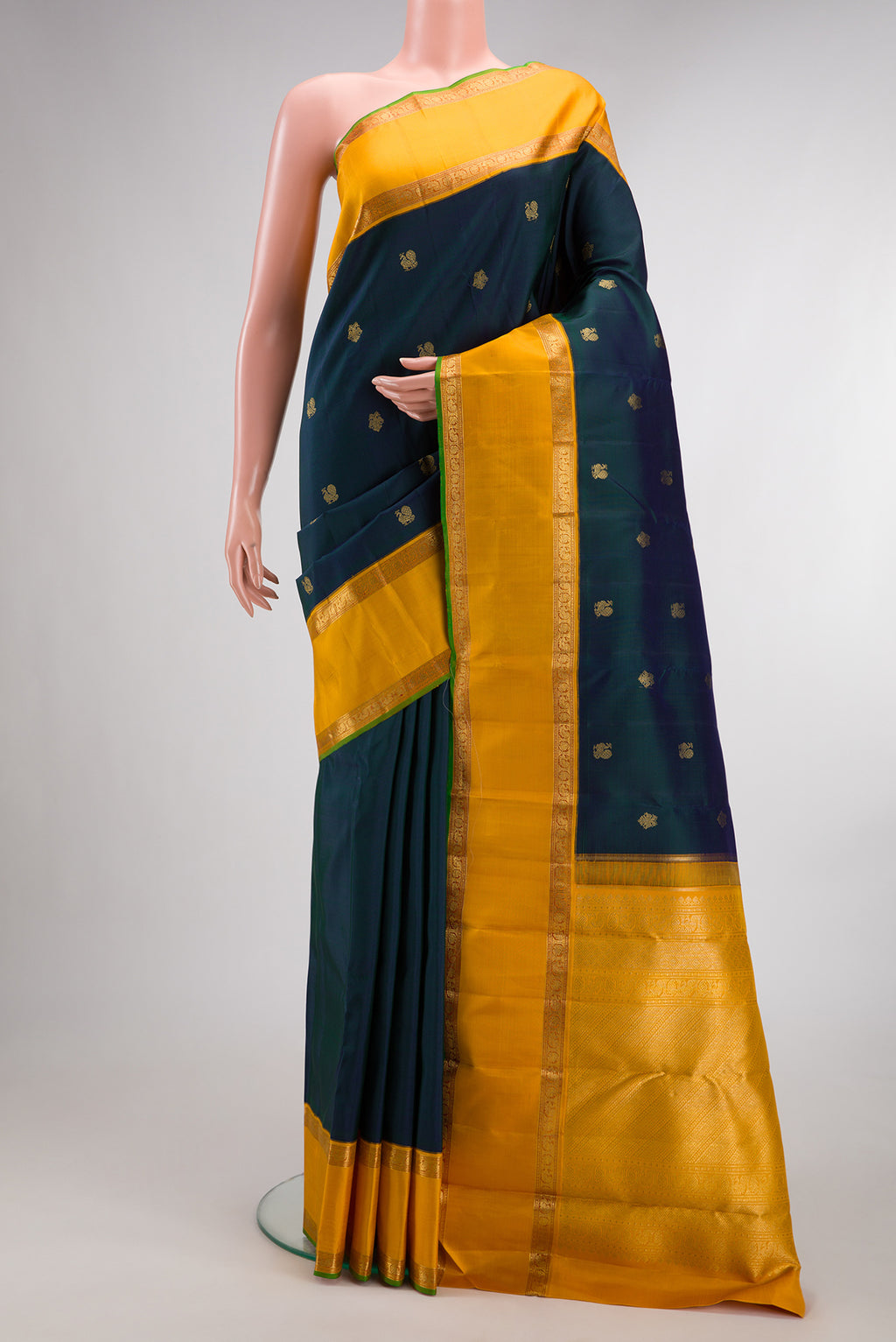 Pure Silk Pure Zari Peacock Blue Dual Tone Kanjivaram Saree with Zari Butta on the body and Zari Border.  displayed on a mannequin