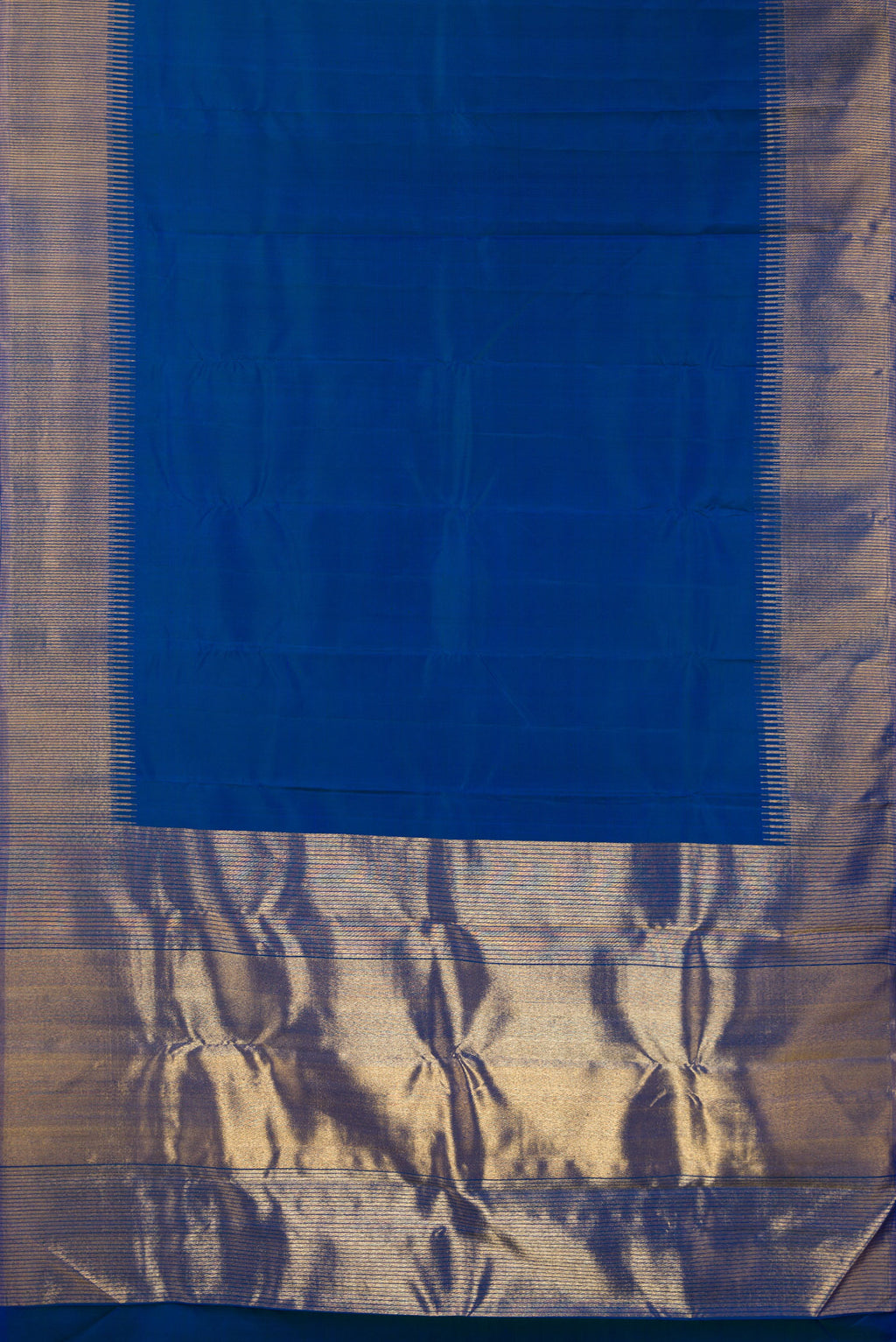 Flat view of Pure Silk Blue Kanchipuram Saree with Plain Body and Zari Border. 
